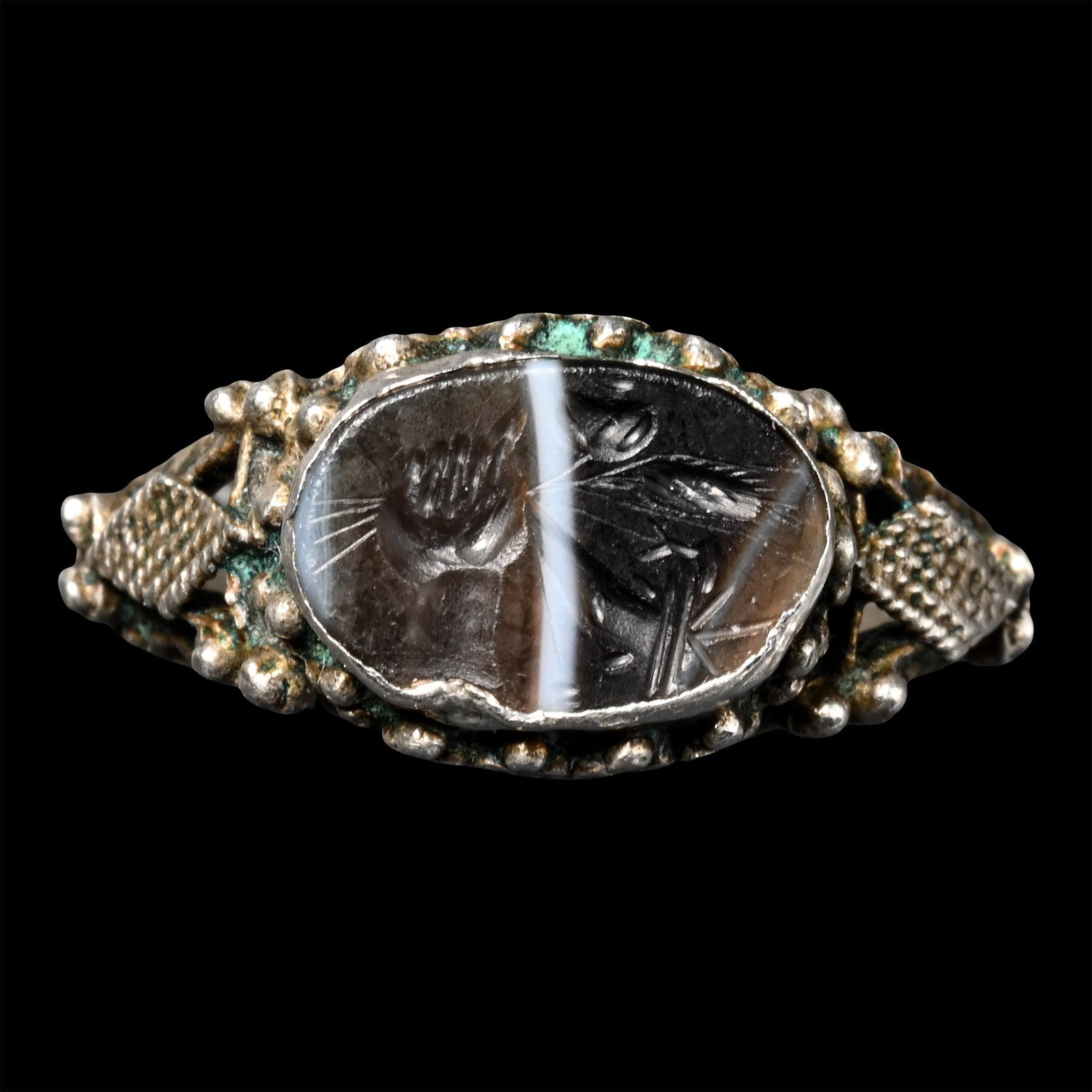 Roman Sardonyx Gemstone in Silver Ring: 1st century B.C. An oval intaglio showing a hand with summum bonum: cornucopia and poppy ear, set in a later ring with granulation; supplied with a museum-quality impression. 3.37 grams, 23.00 mm over