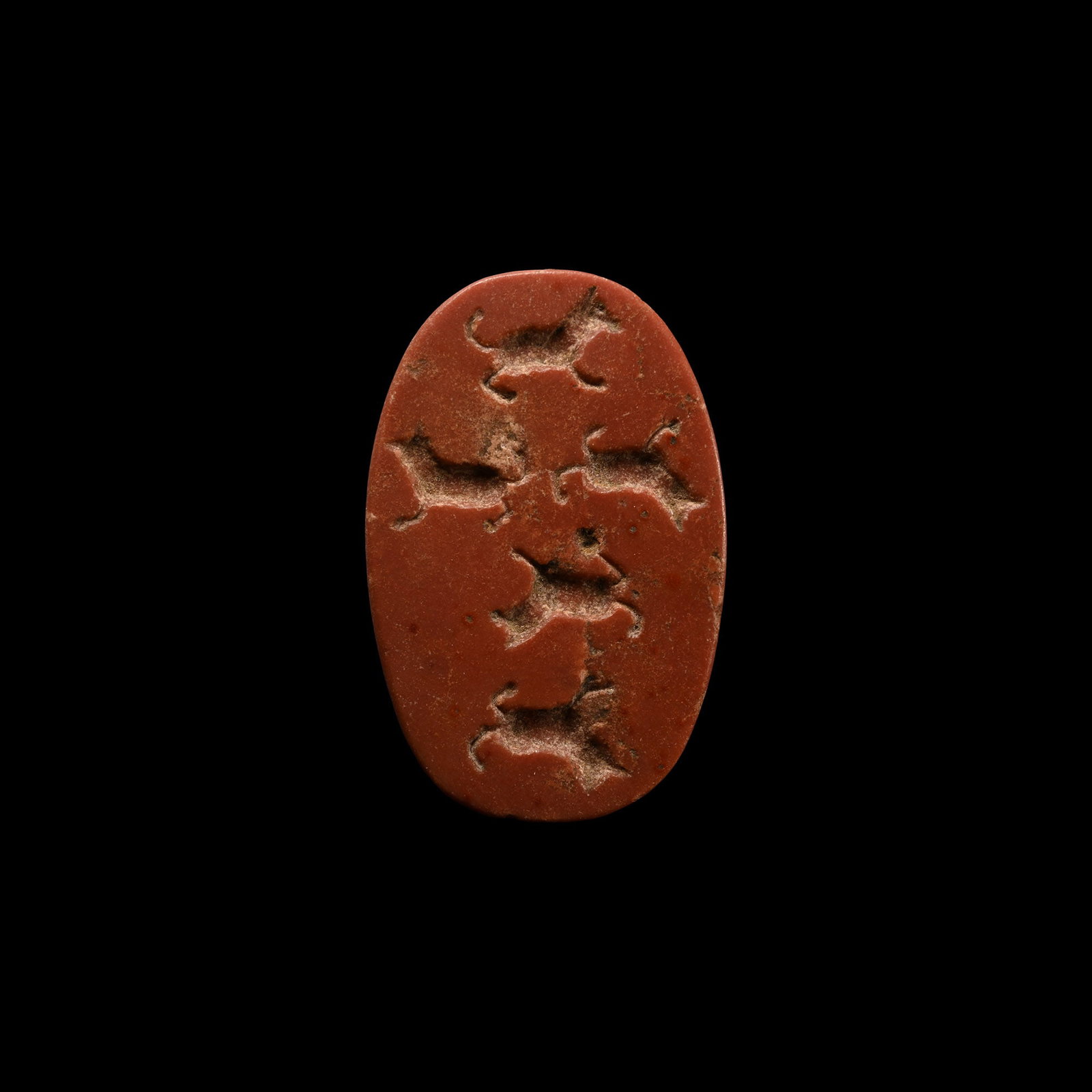 Large Akkadian Red Jasper Seal: Circa 2200 B.C. Plano-convex in section with incuse animal forms to the underside. Cf. Akkadian seal in jasper with similar figures of animals in Wilson, J.A., Allen, T.G. Ancient Oriental Cylinder an