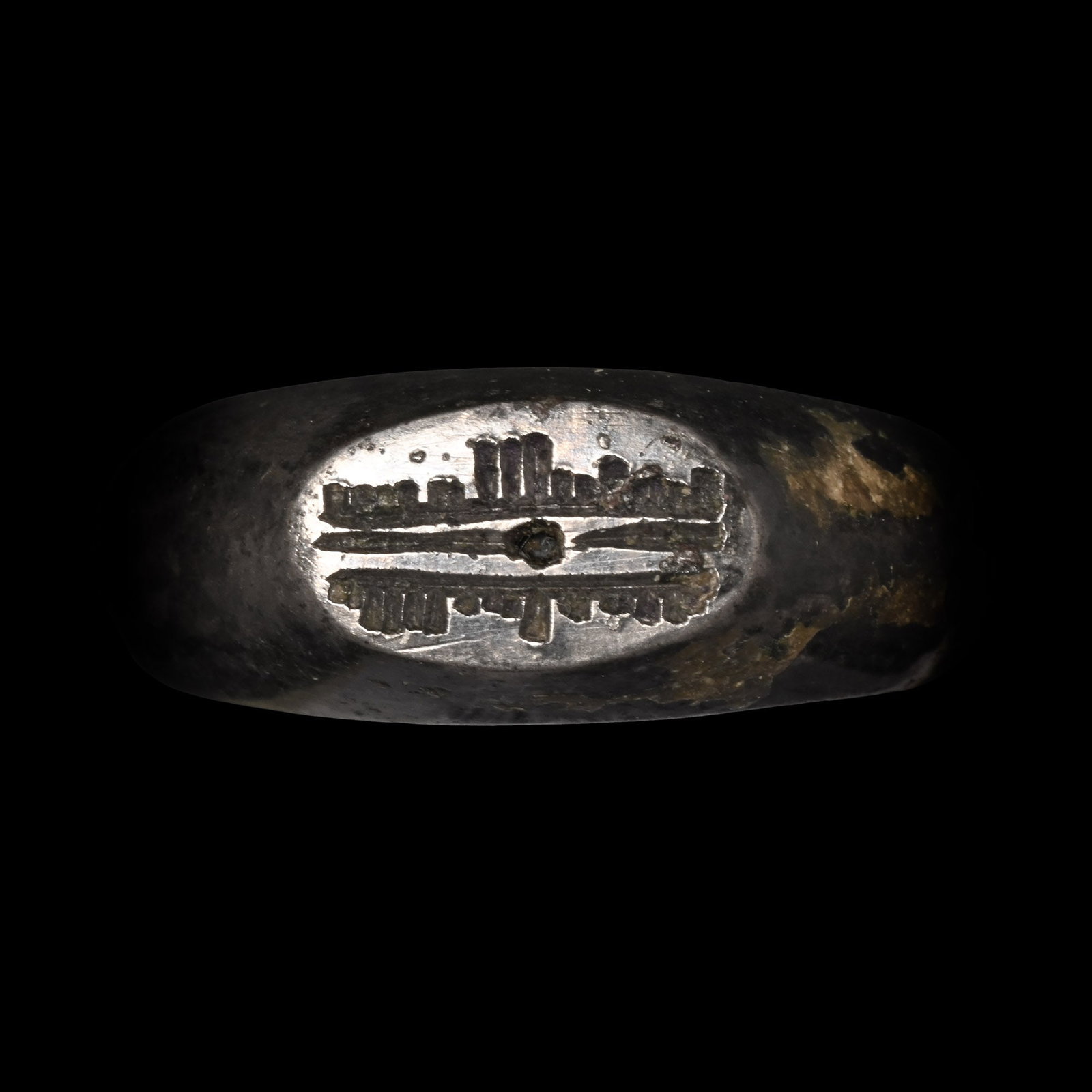 Western Asiatic Silver Ring with Calligraphic Inscription: Circa 8th-10th century A.D. Comprising a D-section hoop expanding towards the shoulders, a raised oval bezel with a two-line cursive Kufic inscription. 8.28 grams, 22.88 mm overall, 17.46 mm internal 