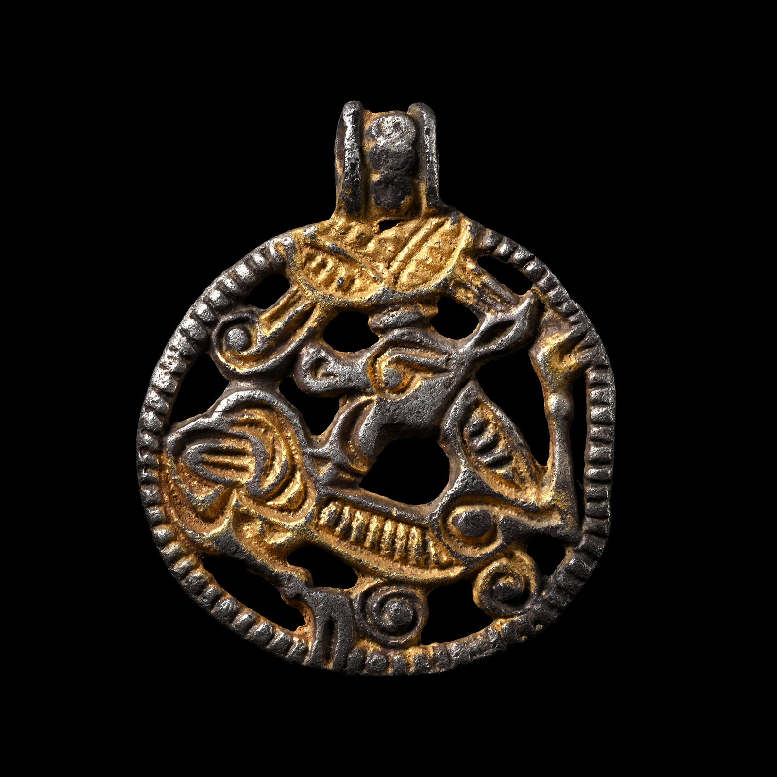 Scandinavian Viking Silver Pendant with Beast Facing Back: 9th-11th century A.D. Openwork pendant with integral loop, pelleted rim, profile beast with head turned to the rear, parcel gilt detailing. Cf. Franceschi, G., Jorn, A. & Magnus, B., Fuglen, Dyret og 