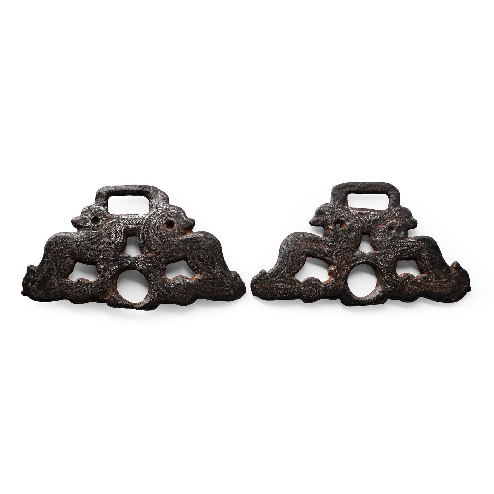 Viking Age Inlaid Iron Horse Bit Cheek Piece Pair with Opposing Beasts: Northern Europe, 11th-12th century A.D. Matched pair of bridle fittings formed as two opposing fantastical creatures with their heads turned back and front legs resting on a globe forming a passage fo