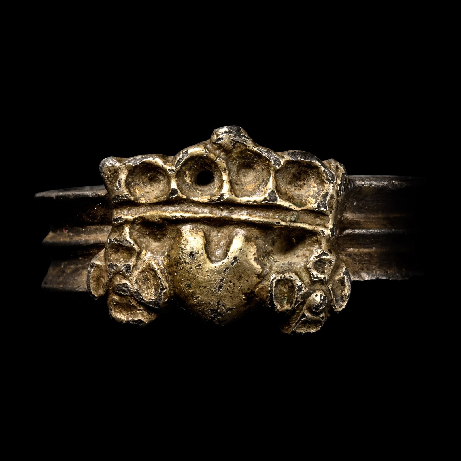 Medieval Silver-Gilt Betrothal Ring: 15th century A.D. Featuring a fluted band with a crowned heart flanked by roses. Cf. for comparable examples, the British Museum, London, museum nos: 1865,0408.61, AF.1114 and SLRings.84. 6.18 grams, 