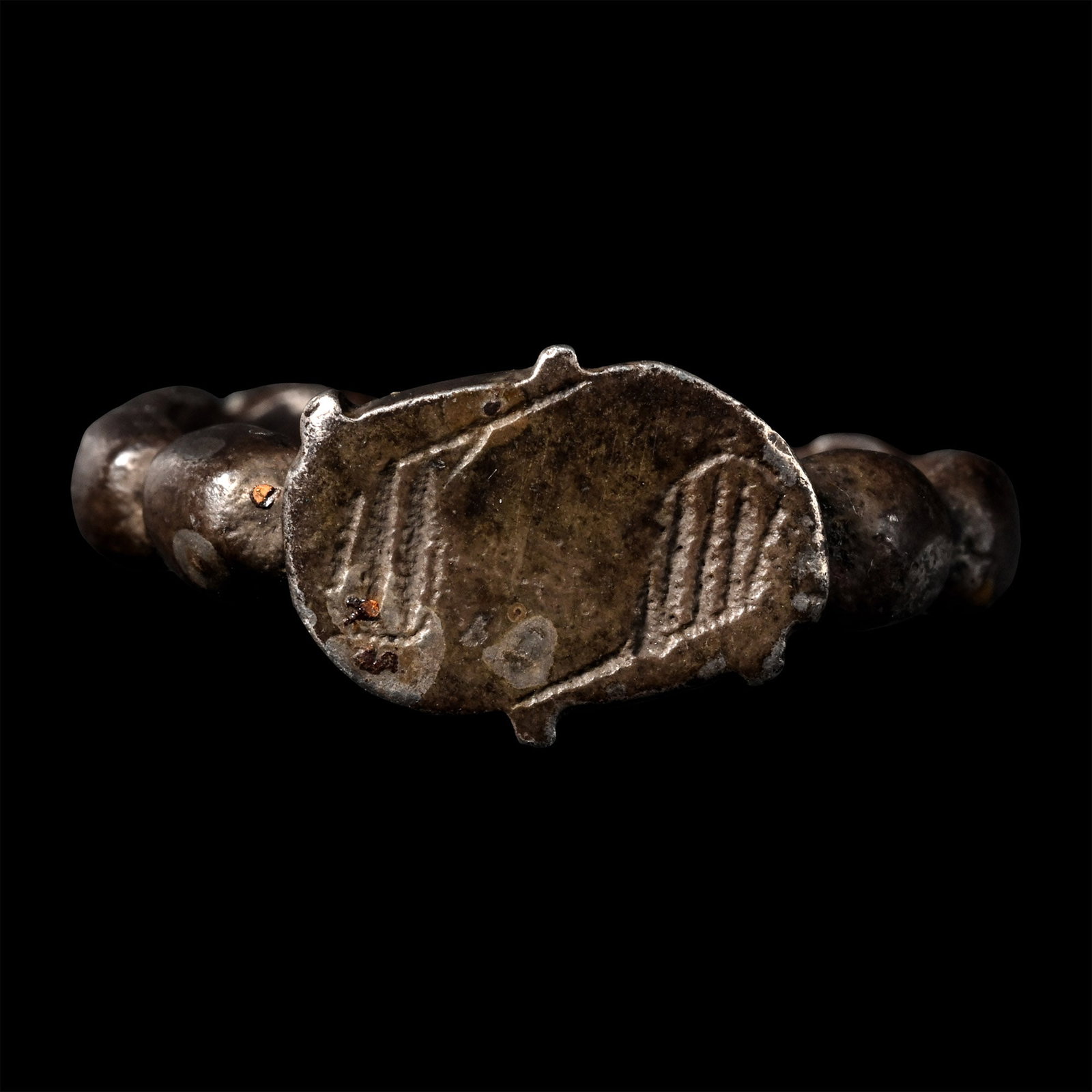 Medieval Silver Ring with 'S' Bezel: England or Germany, 15th century A.D. The hoop formed of ten raised bosses and the bezel in the form of a Lombardic letter ?S?. Cf. Chadour, A.B., Rings. The Alice and Louis Koch collection, Leeds, 19