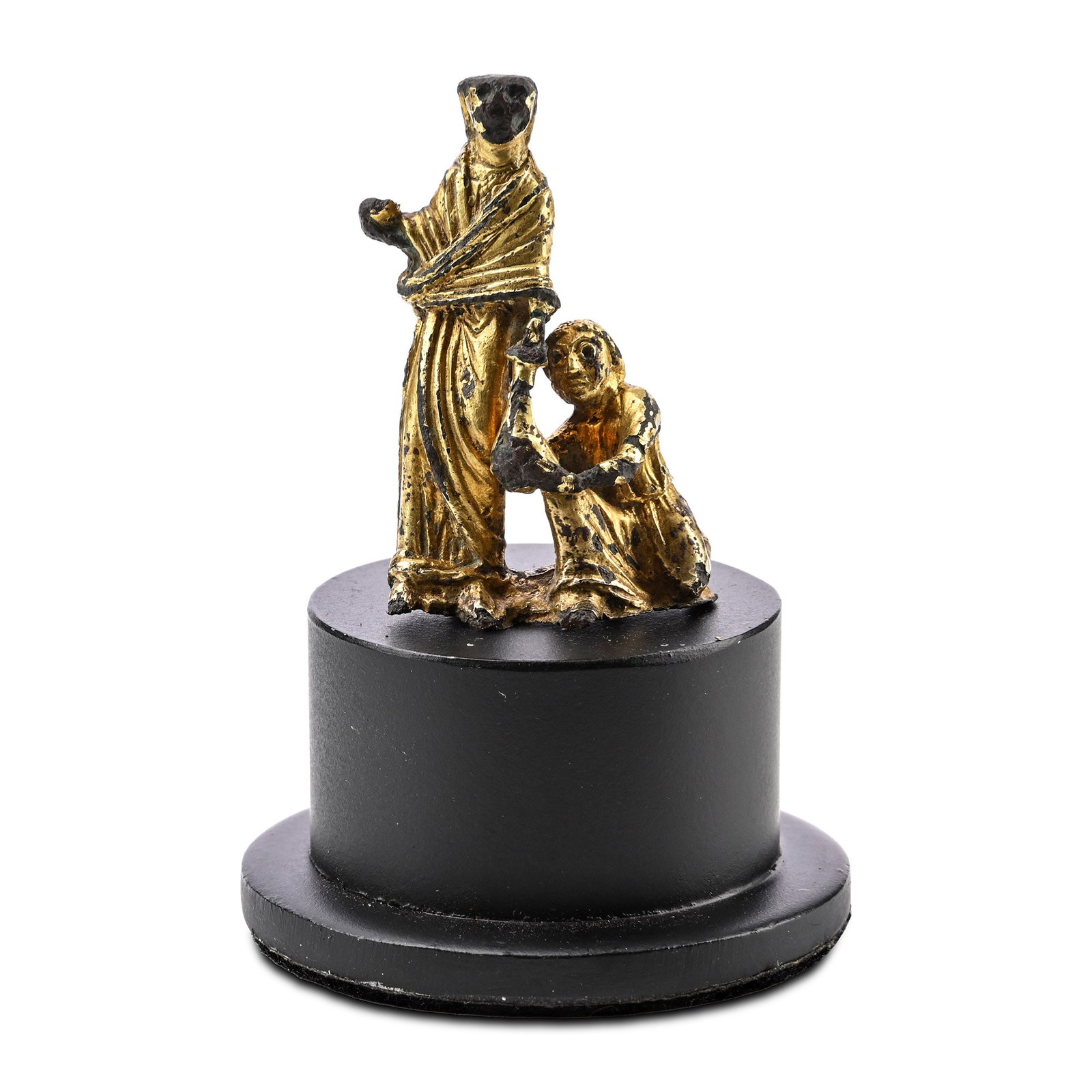 Medieval Gilt Bronze Statue of the Act of Almsgiving: England, 12th century A.D. Featuring a standing figure extending a purse to a kneeling supplicant, an allegory of almsgiving, preserving substantial traces of its original gilding, this rare Romanesqu