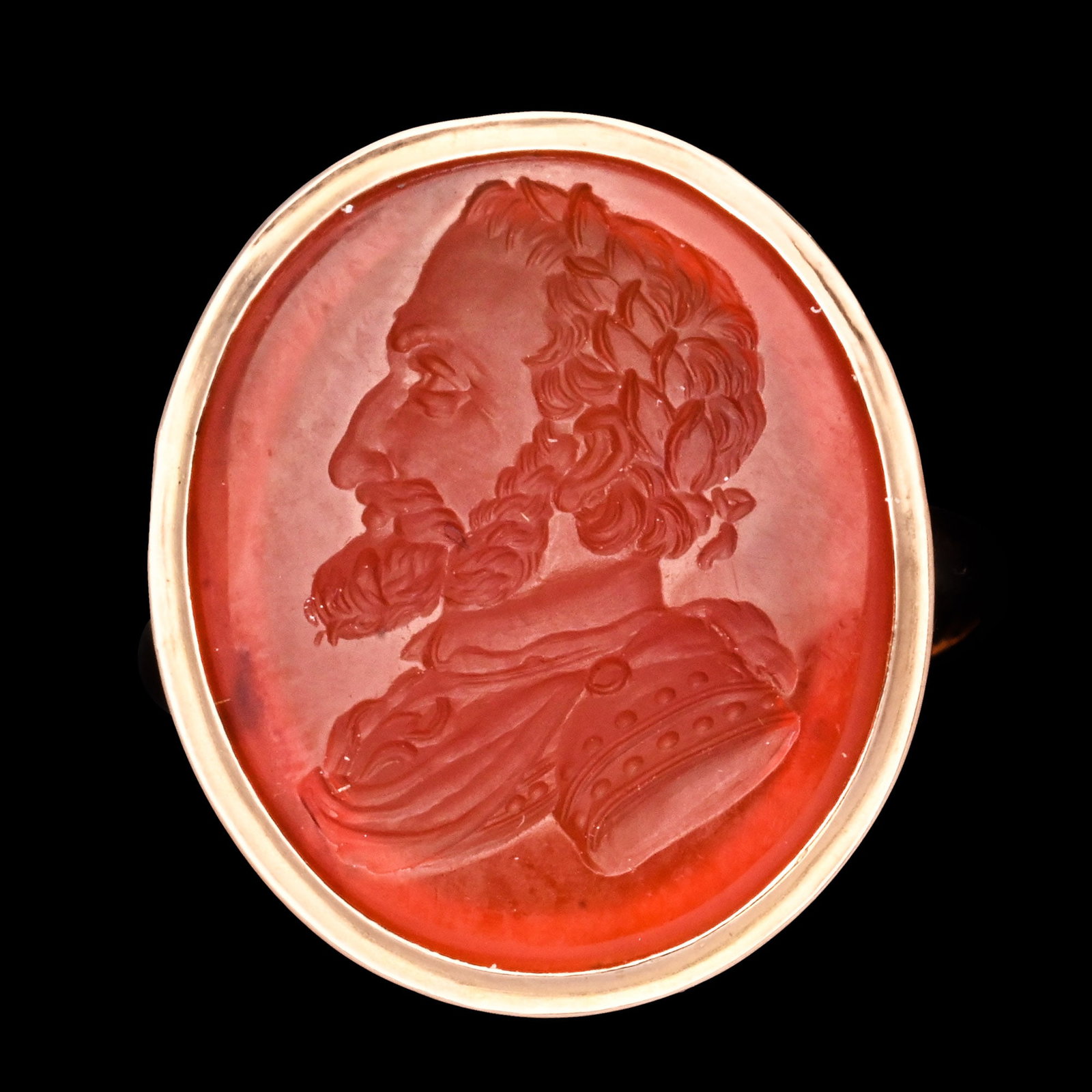 French Carnelian Gemstone with King Henry IV in Gold Ring: 19th century A.D. Finely engraved intaglio portraying a left-facing bust of Henry IV (1553?1610), King of France, in armour, with a decorated gorget and distinctive curled beard, set in a high-carat g