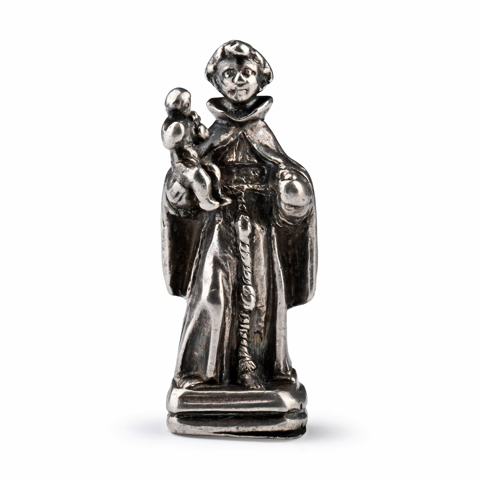 Silver Pendant in the form of Saint Anthony of Padua and Christ Child: Spain, 17th century A.D. Modelled in the round, Saint Anthony standing on a square base and holding the infant Jesus, who is holding a lily in his left hand; the saint dressed in long robes tied at th