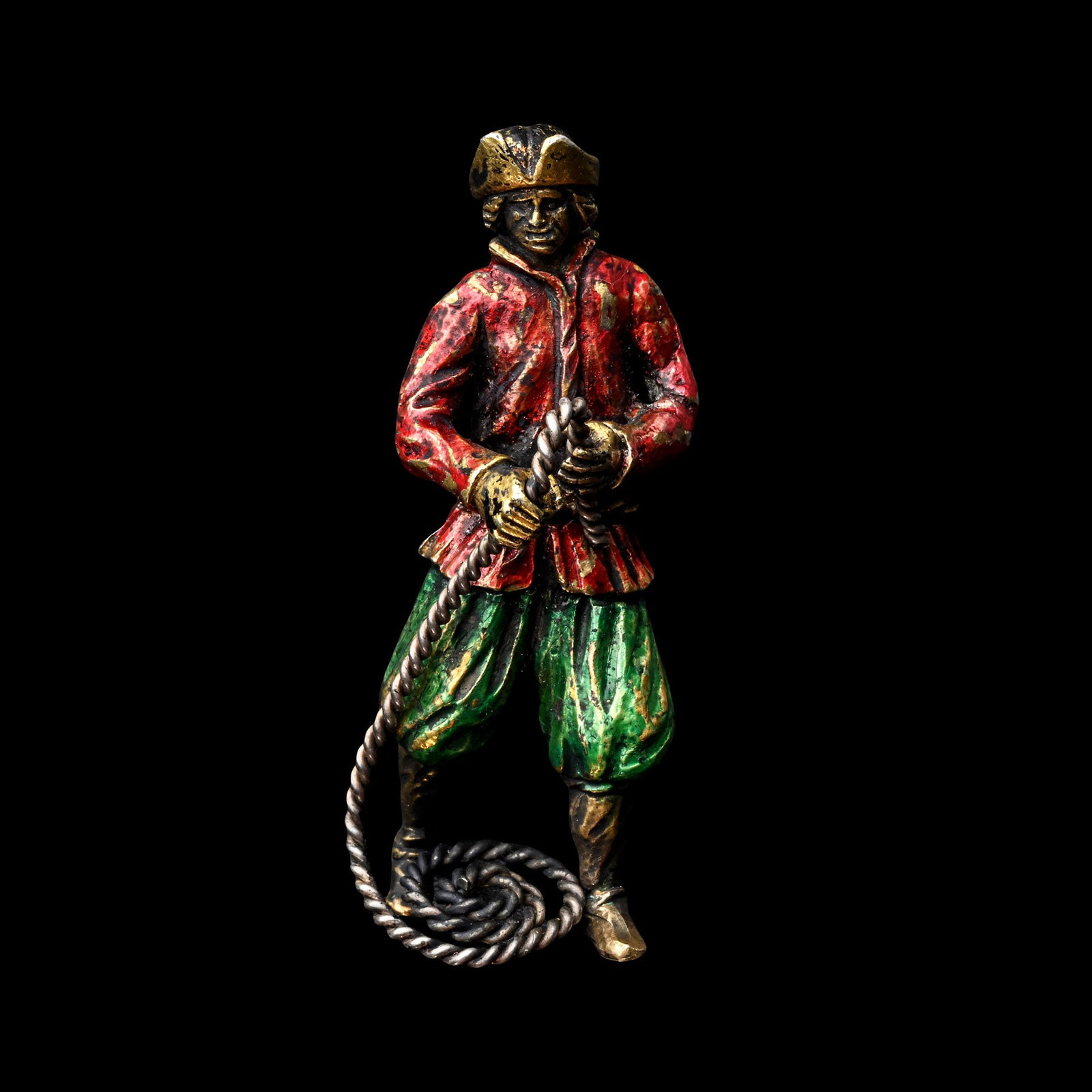 German Silver-Gilt and Enamelled Figure of a Sailor: 17th century A.D. The mariner modelled in a lively stance, holding a coiled rope in both hands, which falls in a naturalistic spiral at his feet, wearing a brimmed and gilt-edged cap, a red enamelled 