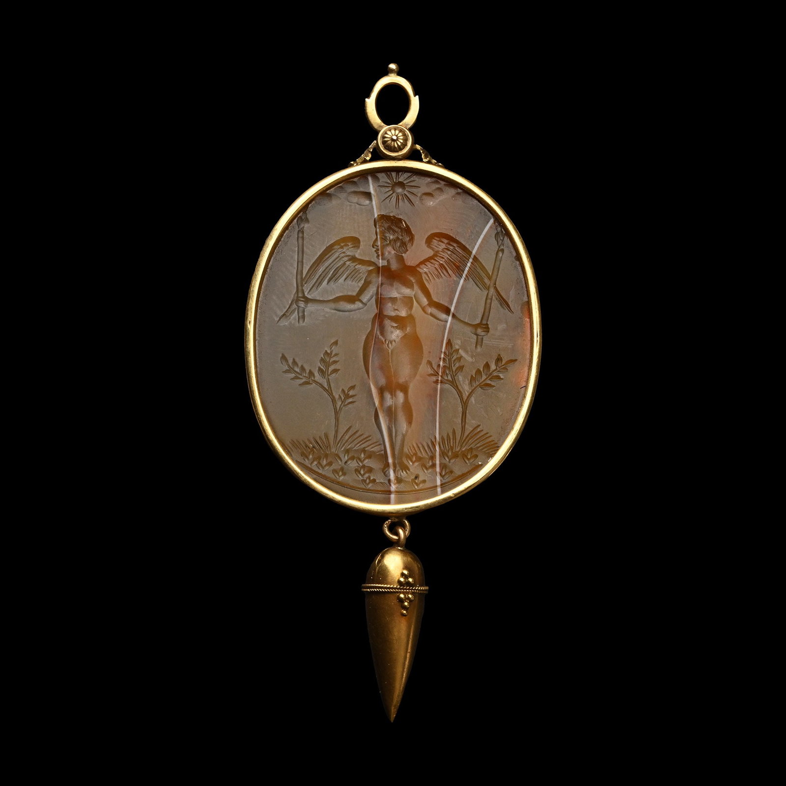 Renaissance Gold Pendant with Agate Gemstone of Cupid: Italy, late 16th-early 17th century A.D. Cupid shown standing amid the vegetation, his wings and arms spread and holding two short staffs in his hands, clouds and the sun above; set in a gold frame wi