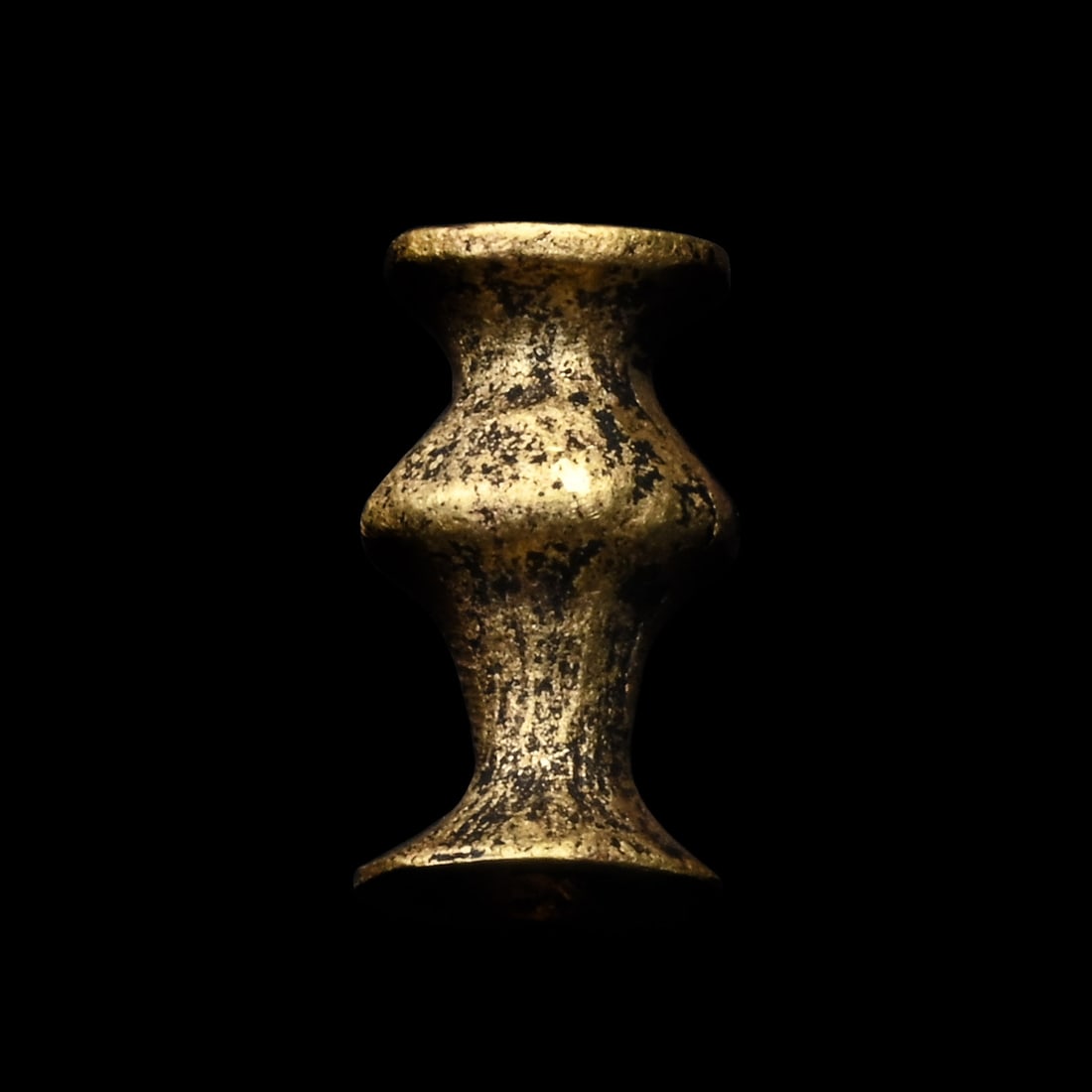 Egyptian Gold Bead Amulet: Late New Kingdom-Third Intermediate Period, circa 1069-900 B.C. Formed as a poppy seed with flaring terminals. 0.91 grams, 9 mm (3/8 in.). Ex French art market, 1920s. TimeLine Auctions follows a rigo