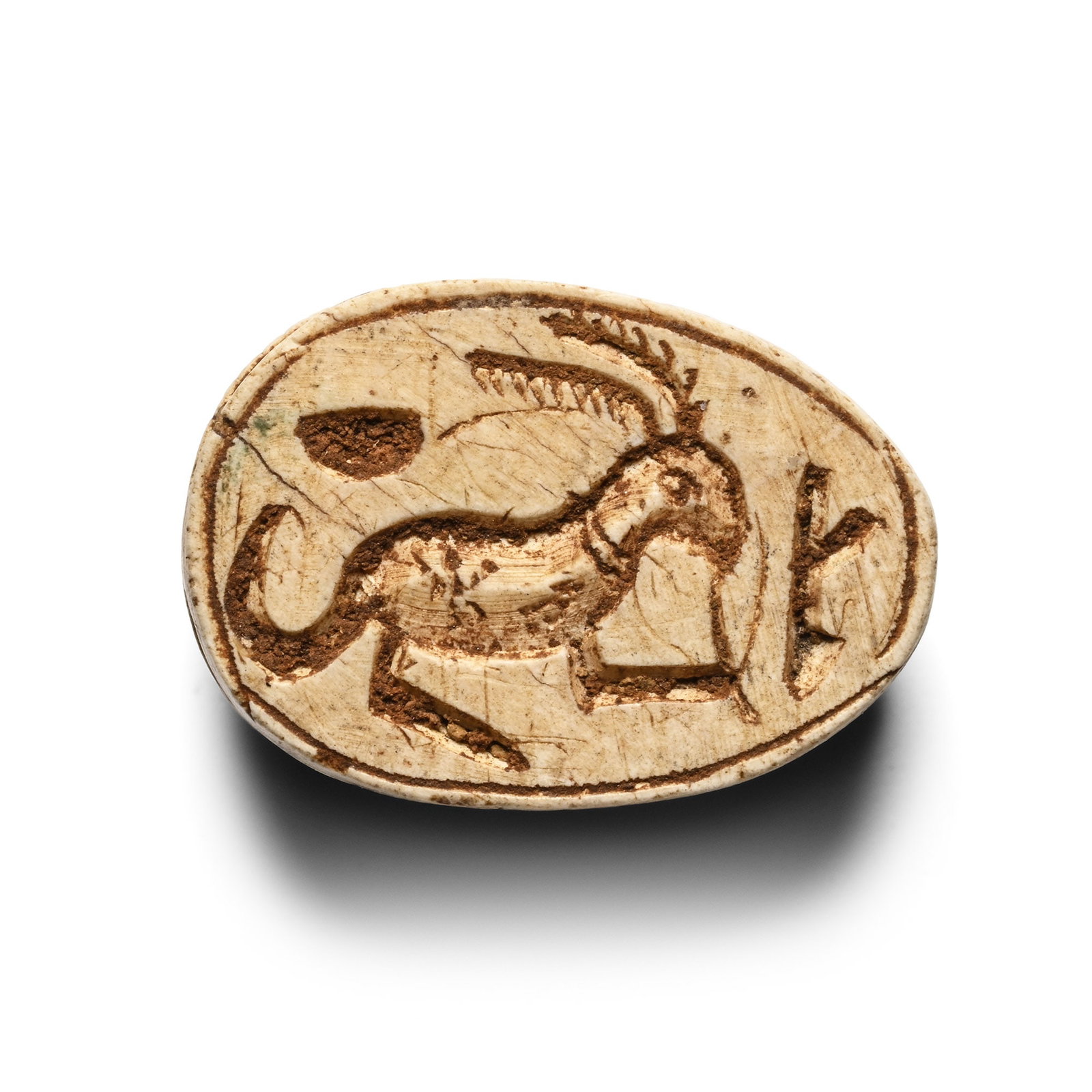 Egyptian Steatite Scarab with Hare: Late Period-Ptolemaic Period, 664-30 B.C. Anatomical detailing on the carapace and pierced longitudinally; underside with a reclining hare and two hieroglyphs. For a similar scarab cf. Ward, J., The S