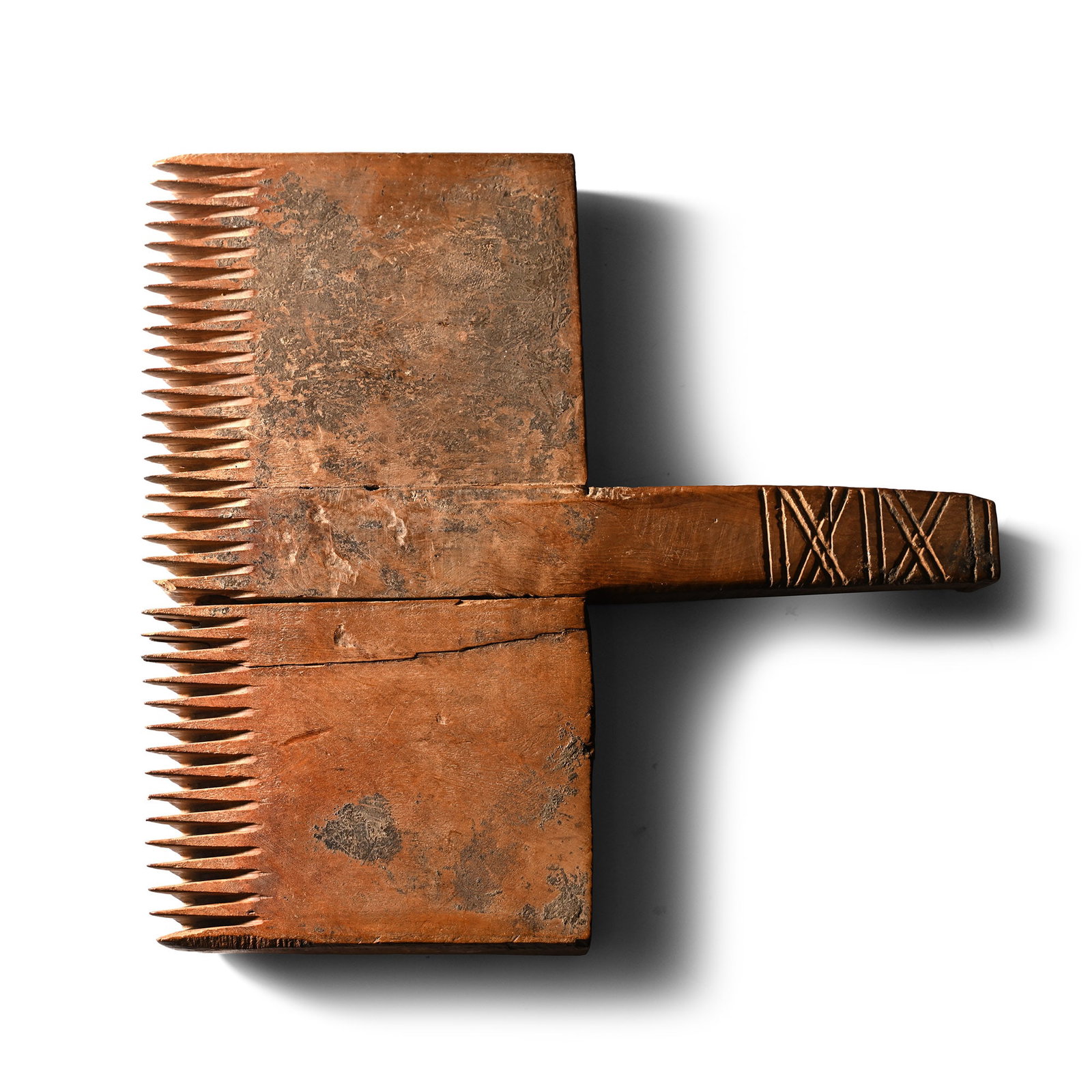 Egyptian Wood Weaving Comb: Coptic, 6th-7th century A.D. With rectangular handle to the rear, teeth to the forward edge; incised saltire decoration to the upper face of the handle. 640 grams, 24.2 cm (9 1/2 in.). [No Reserve] Pr