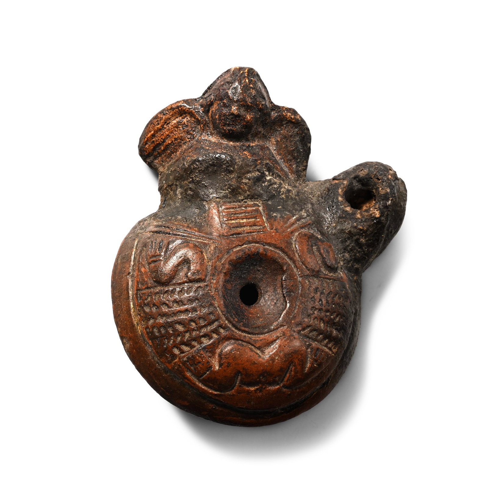 Romano-Egyptian Terracotta Oil Lamp with Eros: Roman Period, 1st-3rd century A.D. Domed body with a small filler hole surrounded by bands of herringbone decoration and zoomorphic motifs, a projecting winged bust of Eros flanking the nozzle, inked 
