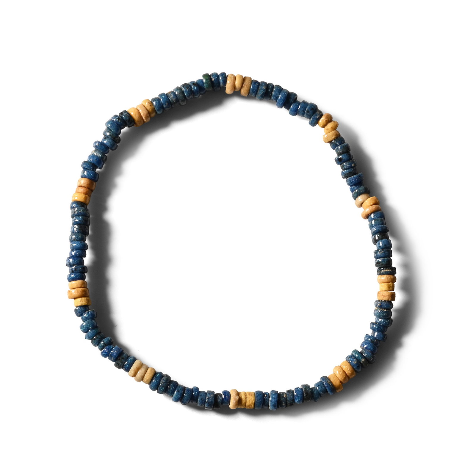 Egyptian Faience Mummy Bead Bracelet: Late Period, 664-332 B.C. Composed of alternating blue and cream annular beads, restrung with an elasticated string. 2.18 grams, 18 cm (7 1/8 in.). [No Reserve] Ex Ancient Art Shop, Windsor, UK, 1990s