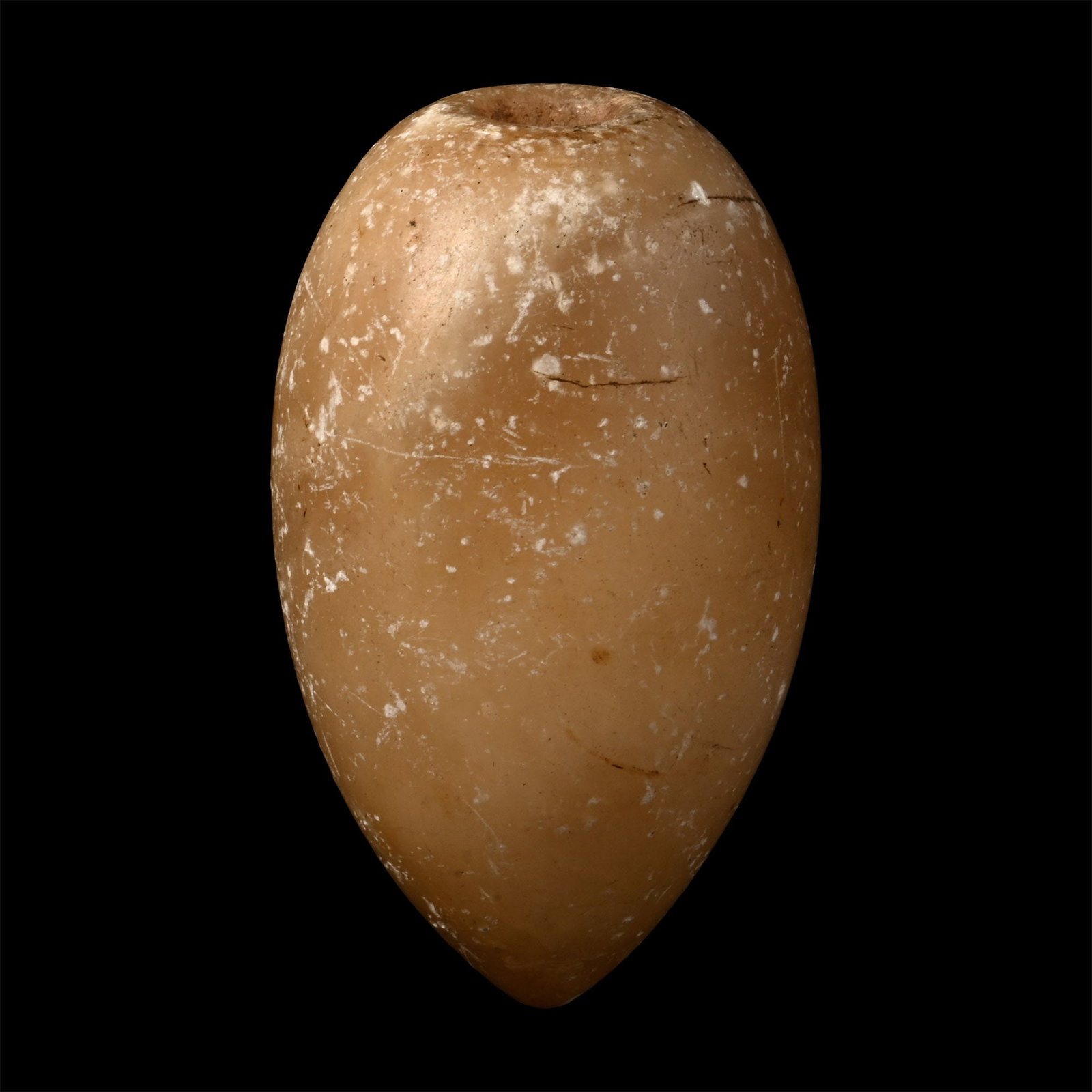 Egyptian Alabaster Miniature 'Torpedo' Flask: Middle Kingdom, 2nd millennium B.C. Ovoid in profile with a pointed base, narrow opening, and hollowed interior. Cf. Vandier d?Abbadie, J., Les objets de toilette ?gyptiens au Mus?e du Louvre, Paris, 