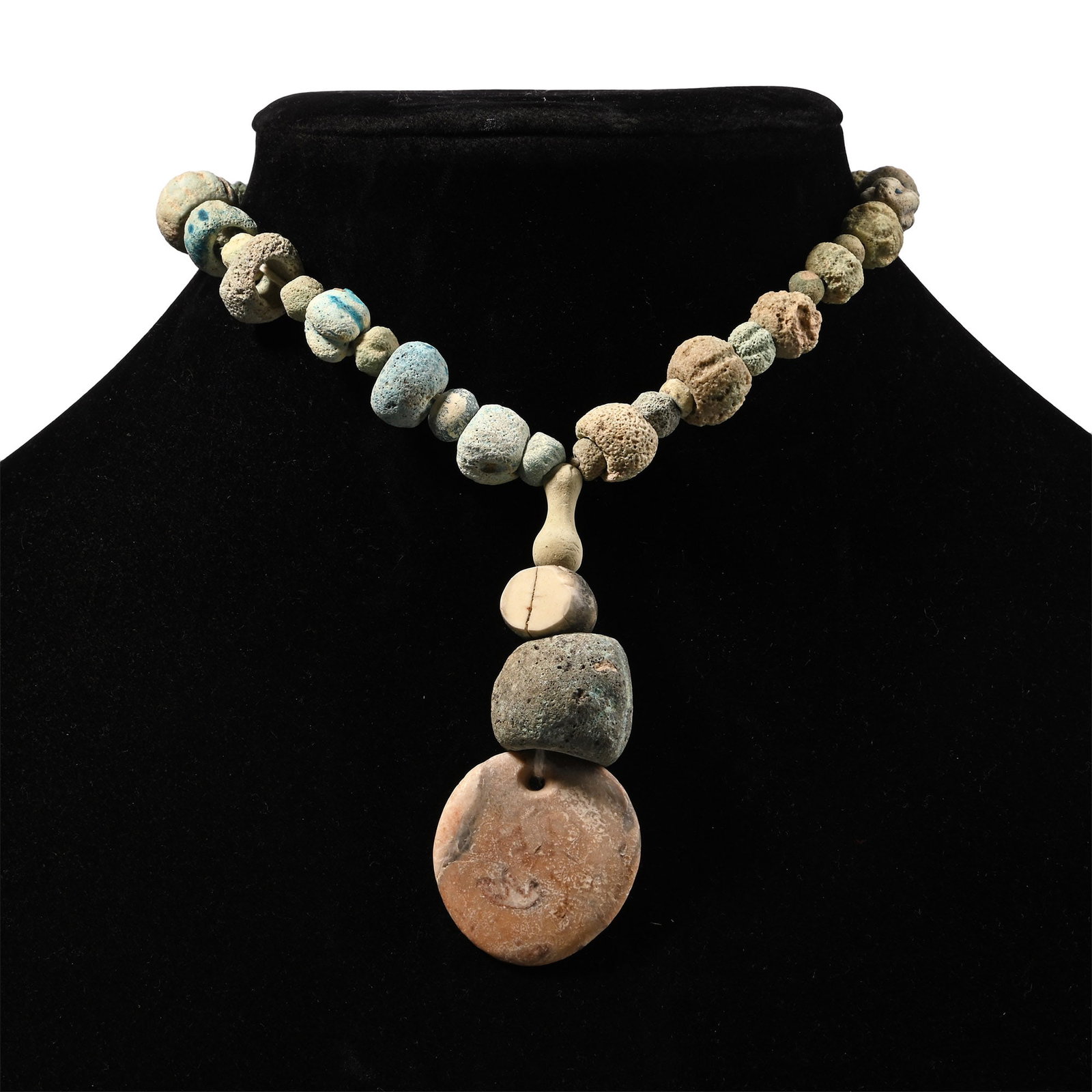 Romano-Egyptian Faience and Other Bead Necklace String: Roman Period, 30 B.C.-323 A.D. Composed mainly of alternating melon and oblate beads, the central feature with a large melon bead and a large discoid pendant, restrung. 42 grams, 29 cm (11 3/8 in.). [