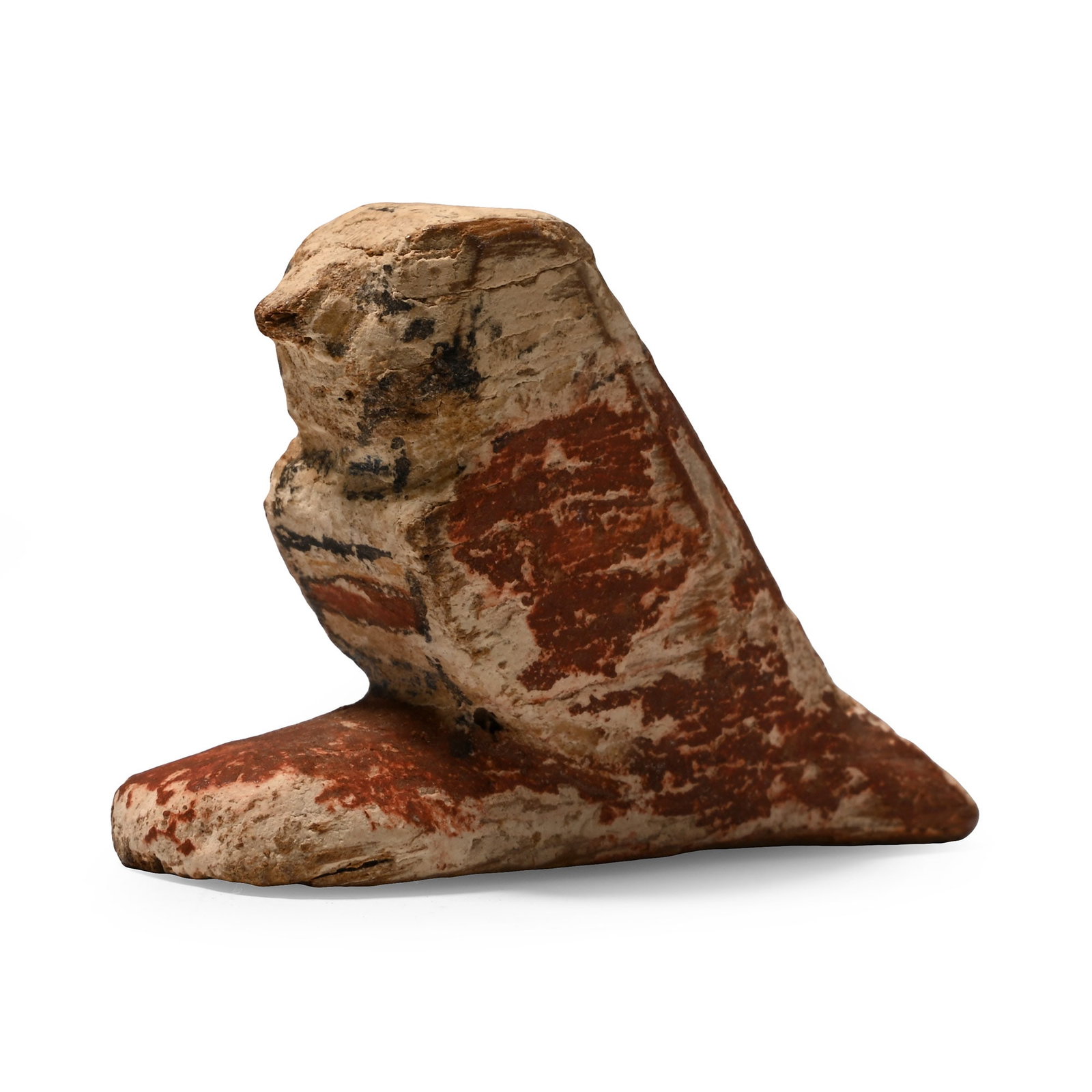Egyptian Polychrome Wooden Sokar Falcon: Late Period, 664-332 B.C. Statuette depicting the couchant falcon god Sokar with wings folded along the sides of the body; chest, wings, and legs with painted details; inked legend on the underside re