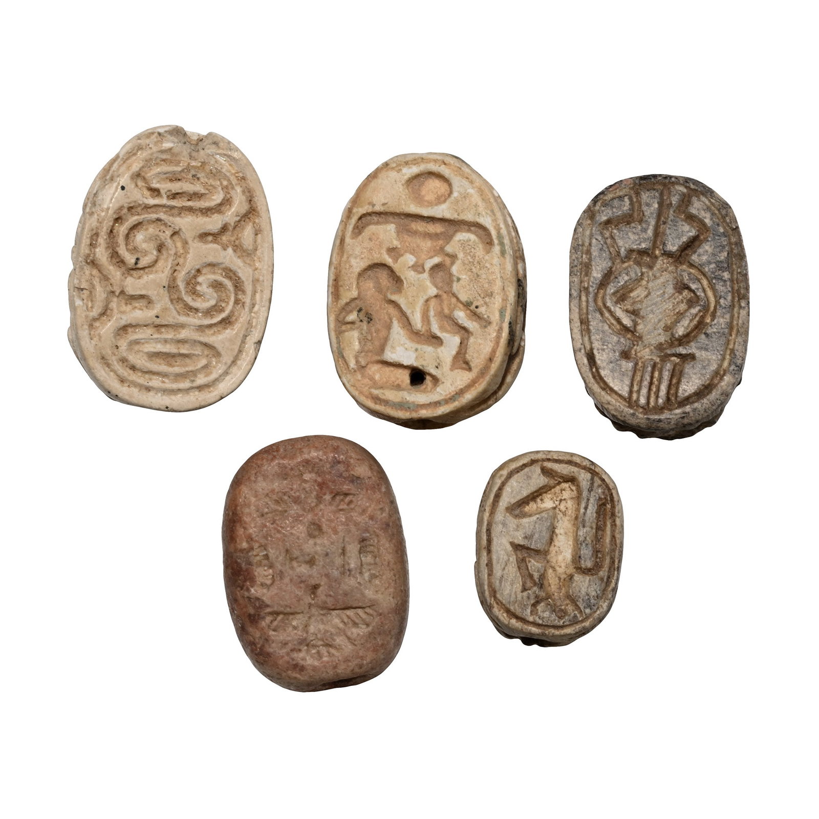 Egyptian and Phoenician Stone Scarab Group: Second Intermediate Period, circa 1650 B.C. and later. Comprising: one with interlocking spirals; one depicting an adult and child with the hieroglyphs for gold (nbw) and the sun disc above; one beari
