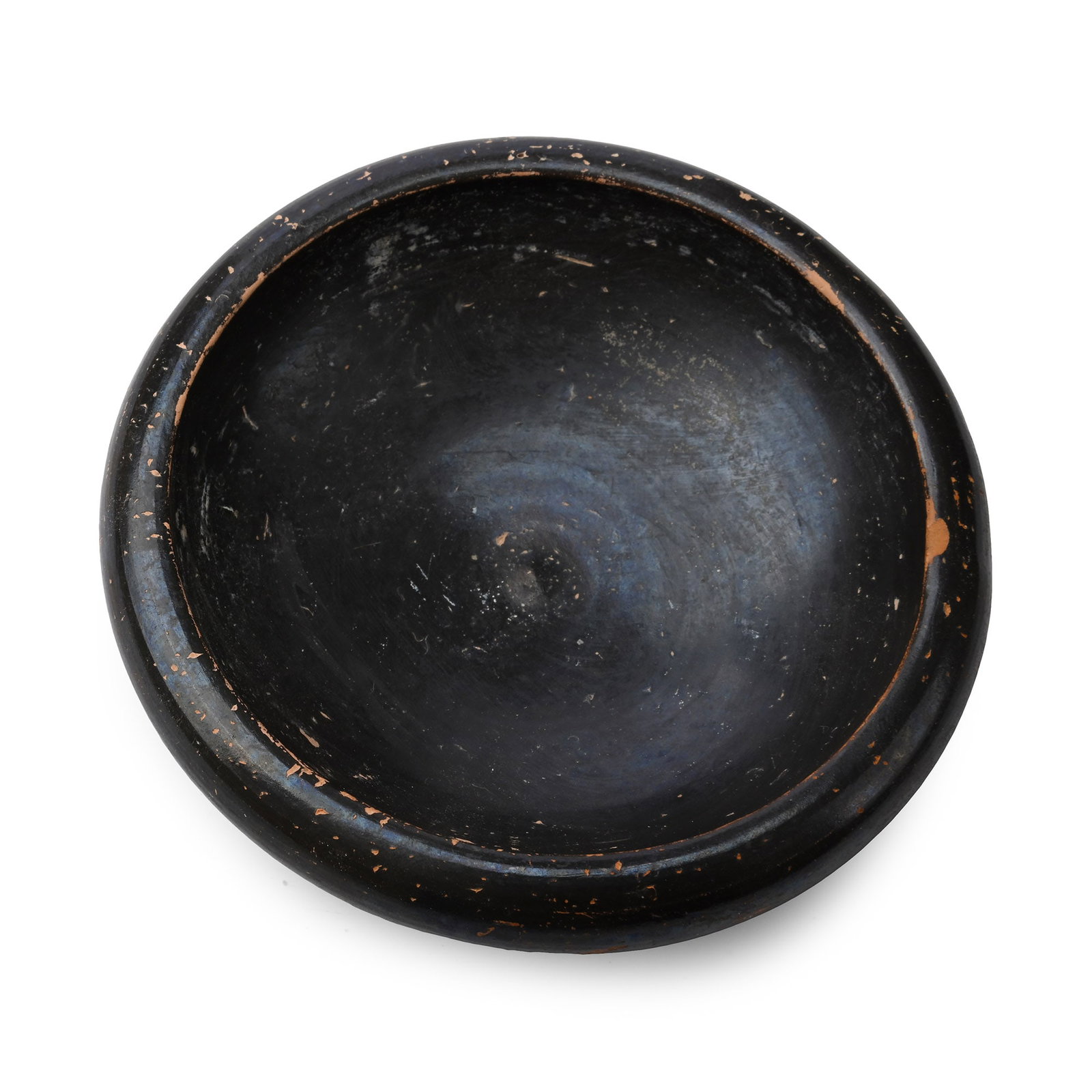 Greek Black Glazed Terracotta Dish: 5th-4th century B.C. Squat in profile with a rounded rim and flared foot. 149 grams, 10.2 cm wide (4 in.). Acquired on the London art market. TimeLine Auctions, 4 June 2017, no.1447. Private collectio