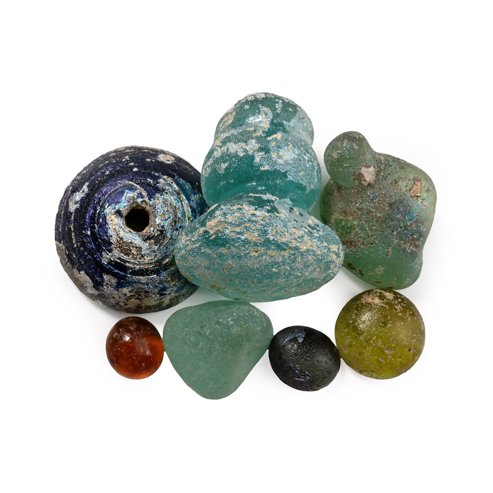 Roman Glass Artefact Collection: 1st-4th century A.D. Including aqua glass stopper with knop handle, plano-convex spindle whorl with iridescent surface and other items; probably used as counters in boardgames. 32 grams total, 9-27 mm