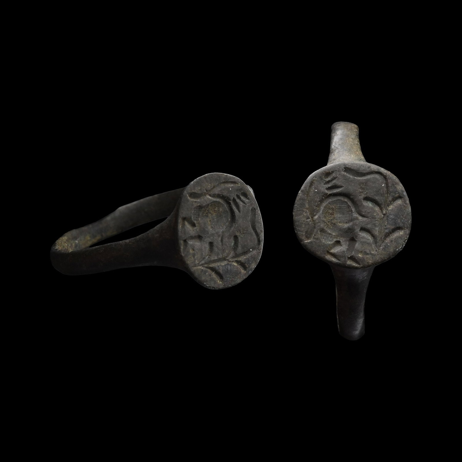 Roman Bronze Ring with Standing Figure and Tree: 3rd-4th century A.D. With a slender hoop and a raised circular bezel with a stylised figure beside a tree. 3.12 grams, 22.89 mm overall, 18.65 mm internal diameter (approximate size British Q, USA 8, 