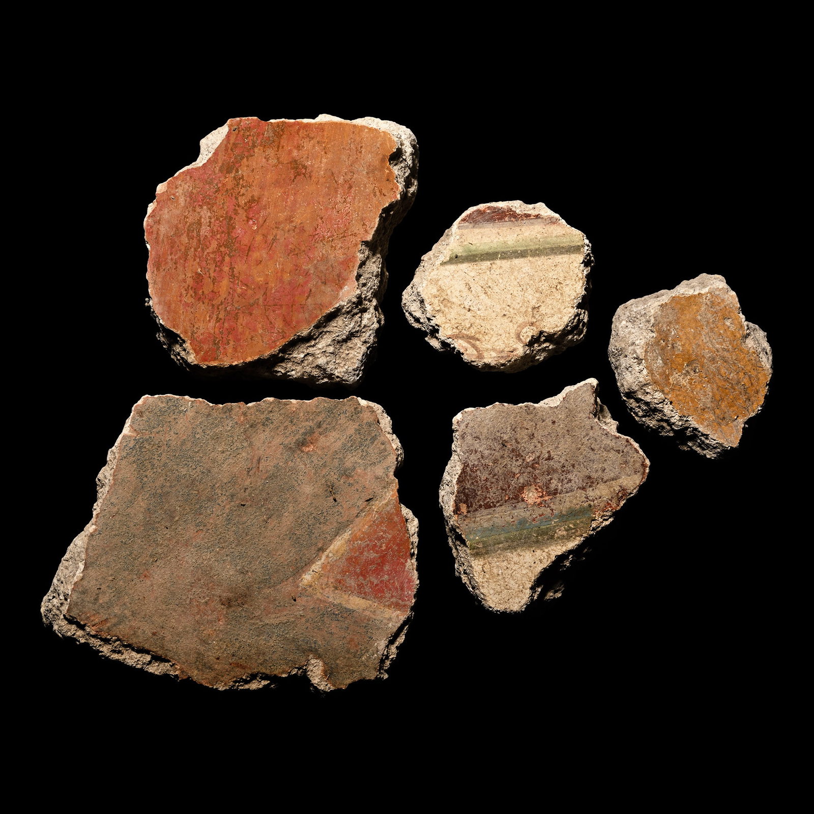 Roman Fresco Wall Plaster Collection: 1st century A.D. Fragments of wall plaster with rendered surface painted with mainly Pompeii red, pale blue, brown, cream and white detailing; some with an impression of timber laths to the reverse. C