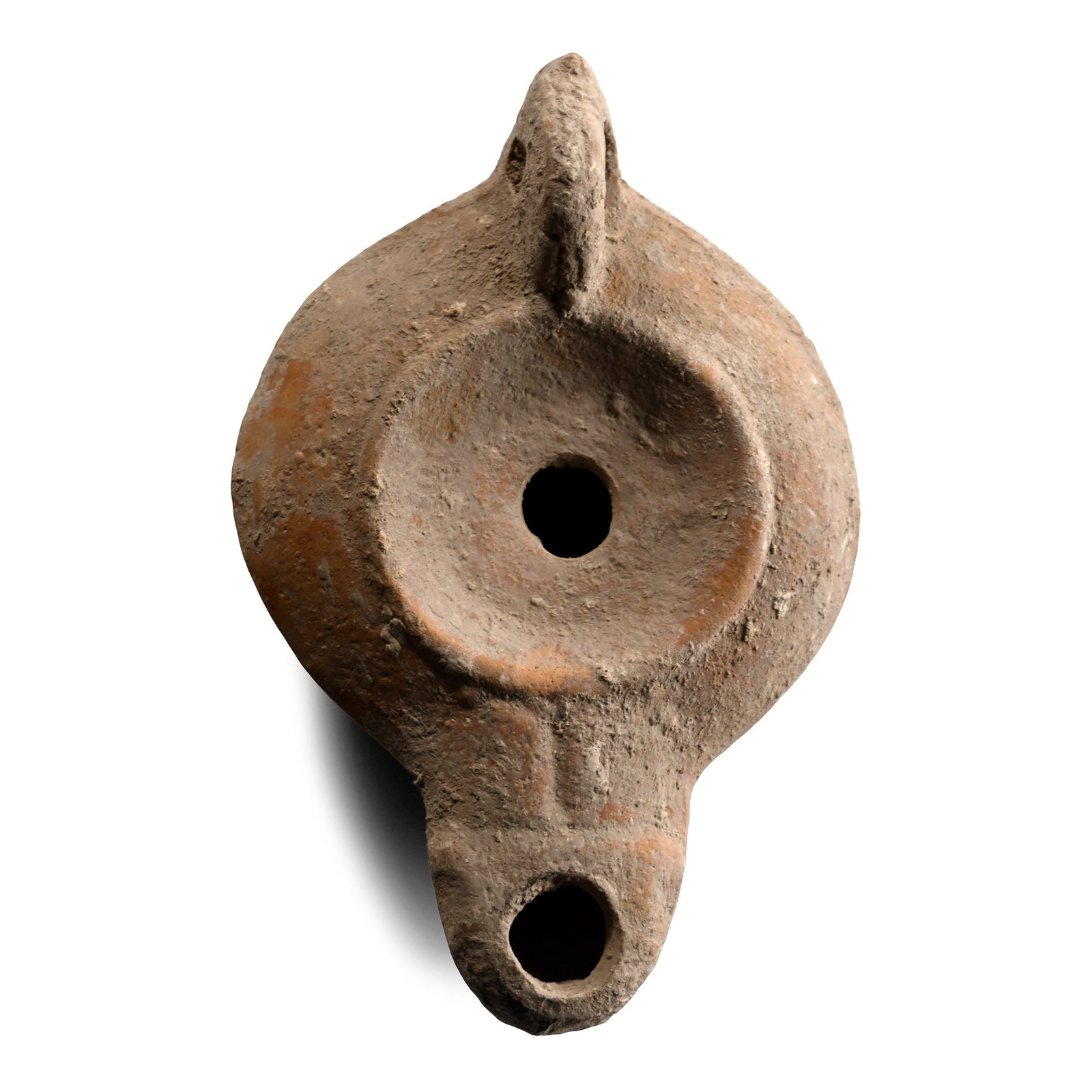 Roman Terracotta Oil Lamp: 2nd century A.D. Squat in profile with broad shoulder and recessed discus with central filler hole; elongated nozzle, carinated sidewall. lug handle with tapering hole. 49 grams, 96 mm (3 3/4 in.). [N