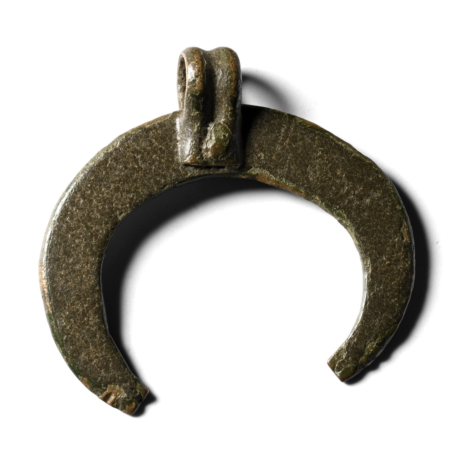 Roman Bronze Lunar Pendant: 1st-2nd century A.D. Crescentic pendant with ribbed suspension loop. 5.16 grams, 37 mm (1 1/2 in.). [No Reserve] Ex German art market, 2000s. Acquired from an EU collector living in London. From the c