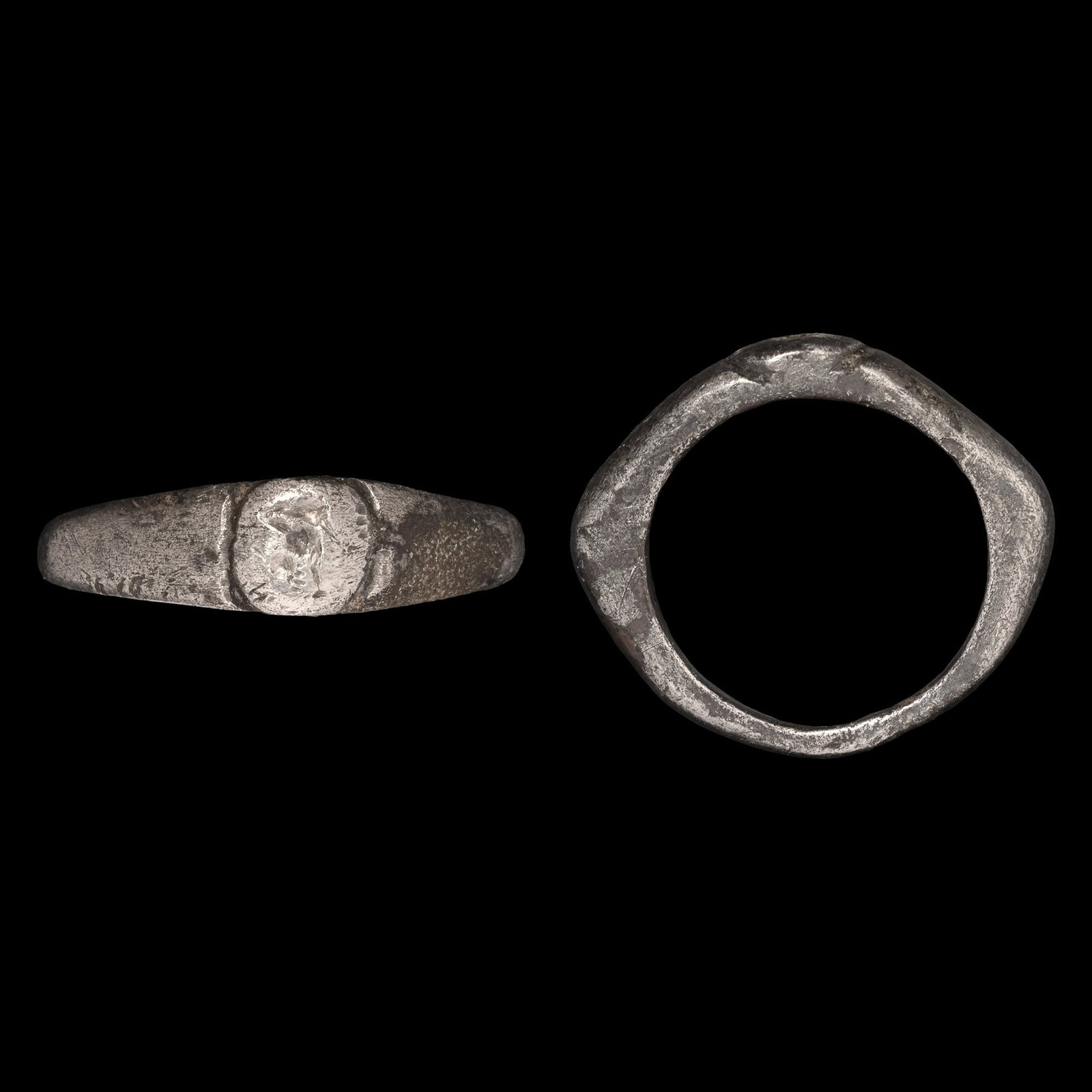 Roman Silver Ring with Animal: 3rd-4th century A.D. Featuring a D-section hoop with angled shoulders and the bezel with a creature facing left. 6.05 grams, 23.52 mm overall, 16.37 mm internal diameter (approximate size British K 1/