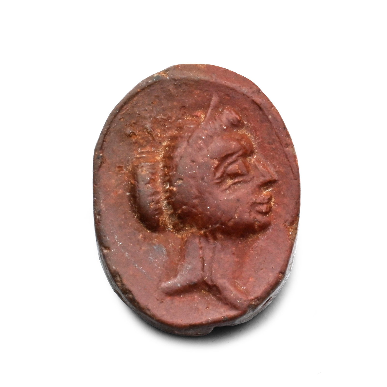 Roman Brown Stone Cameo with Female Bust: 2nd-3rd century A.D. Ellipsoid in plan with a low-relief female profile portrait bust with hair dressed in a chignon. 0.57 grams, 13 mm (1/2 in.). [No Reserve] Property of a European gentleman, acquir