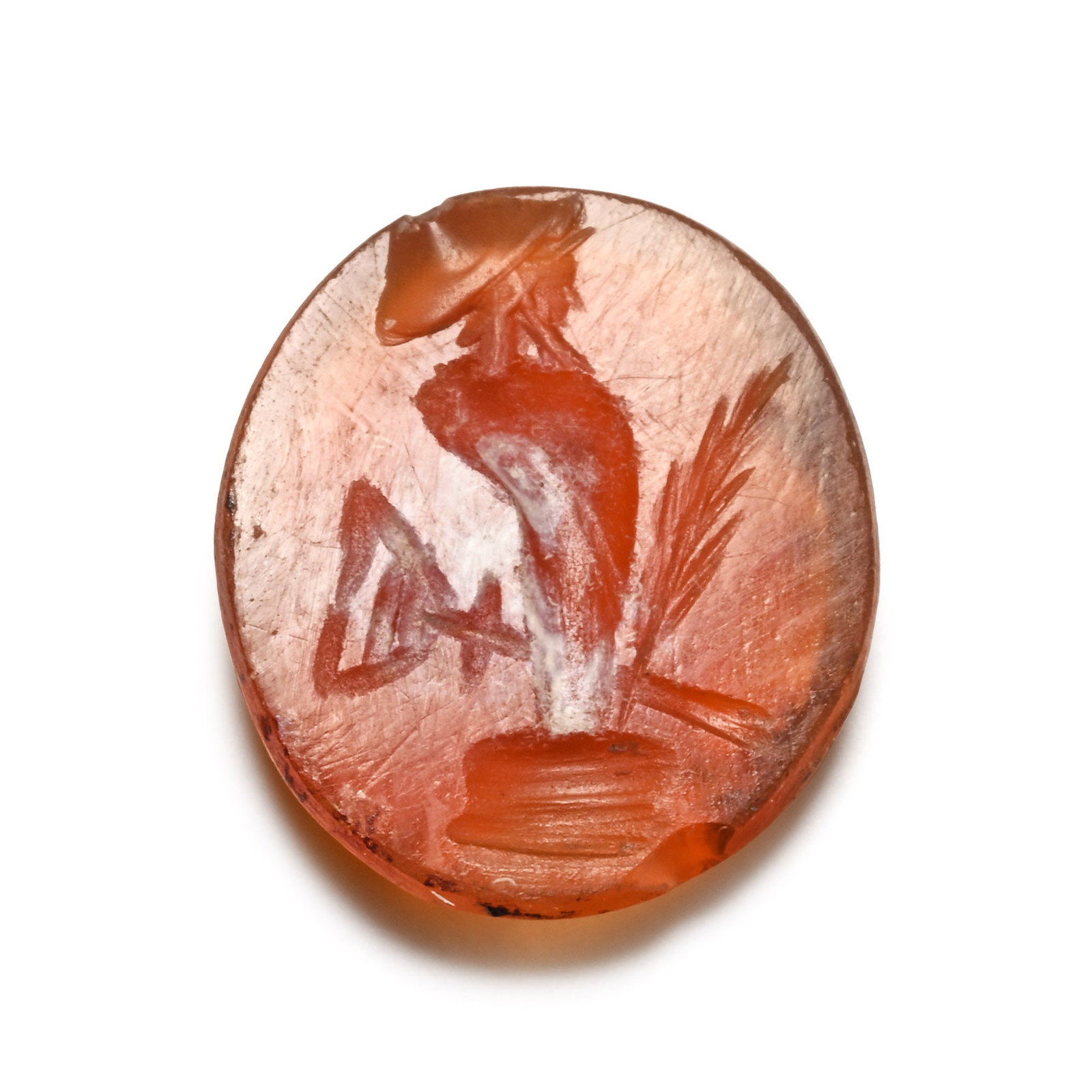 Roman Carnelian Gemstone with Herm: 2nd-3rd century A.D. Ellipsoid type with incuse design to the underside of herm on a pedestal with frond. 0.47 grams, 11 mm (3/8 in.). [No Reserve] From the private collection of a European gentleman 