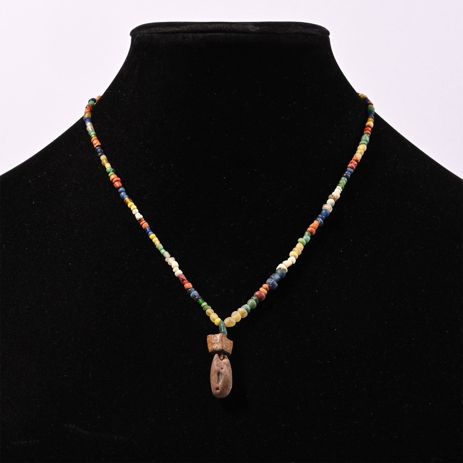 Roman Mixed Glass and Other Bead Necklace String: 1st-4th century A.D. and later. Composed of polychrome oblate and annular beads with two larger beads as a central feature, restrung. 10.5 grams, 38 cm (15 in.). [No Reserve] Ex Ancient Art Shop, Wind