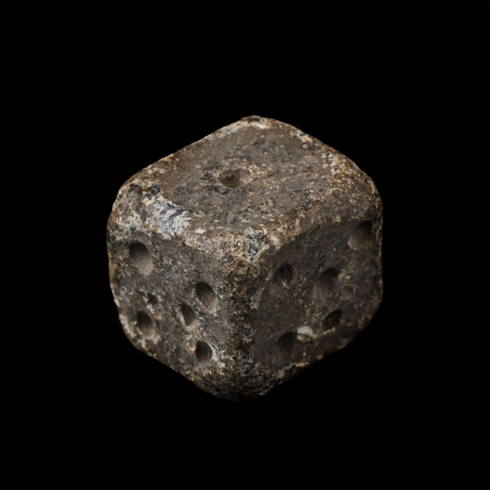 Roman Lead Gaming Die: Circa 1st-4th century A.D. Cuboid dice with impressed markings unusually disposed 1:6, 2:5, 3:5. 12.1 grams, 11 mm (1/2 in.). [No Reserve] Ex gentleman collector of antique and antiquity games from Be