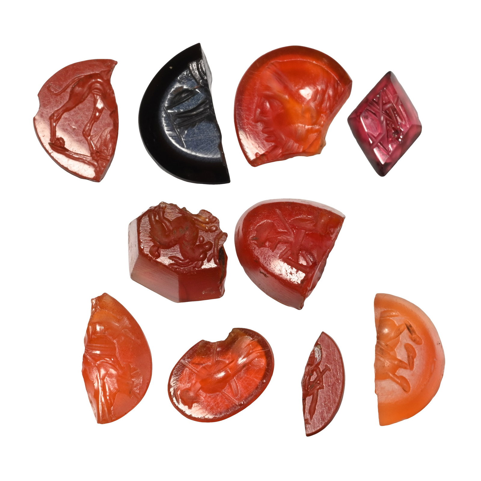 Roman Gemstone Group: 2nd-3rd century A.D. Including advancing rear legs of a lion, profile bust, Minerva with spear and other types; each supplied with a museum-quality impression. 3 grams total, 8-12 mm (1/8 - 1/2 in.). 