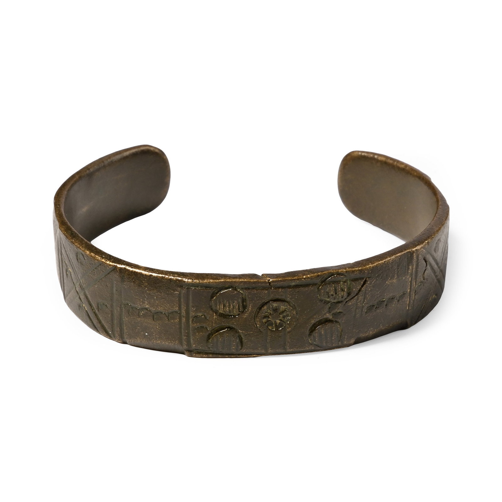 Late Roman Bronze Decorated Bracelet: 5th-6th century A.D. Penannular bracelet with rounded terminals, the upper face decorated with annulets and X-motifs, five large circlets with hatching at the centre. 30.2 grams, 57 mm (2 1/4 in.). [N