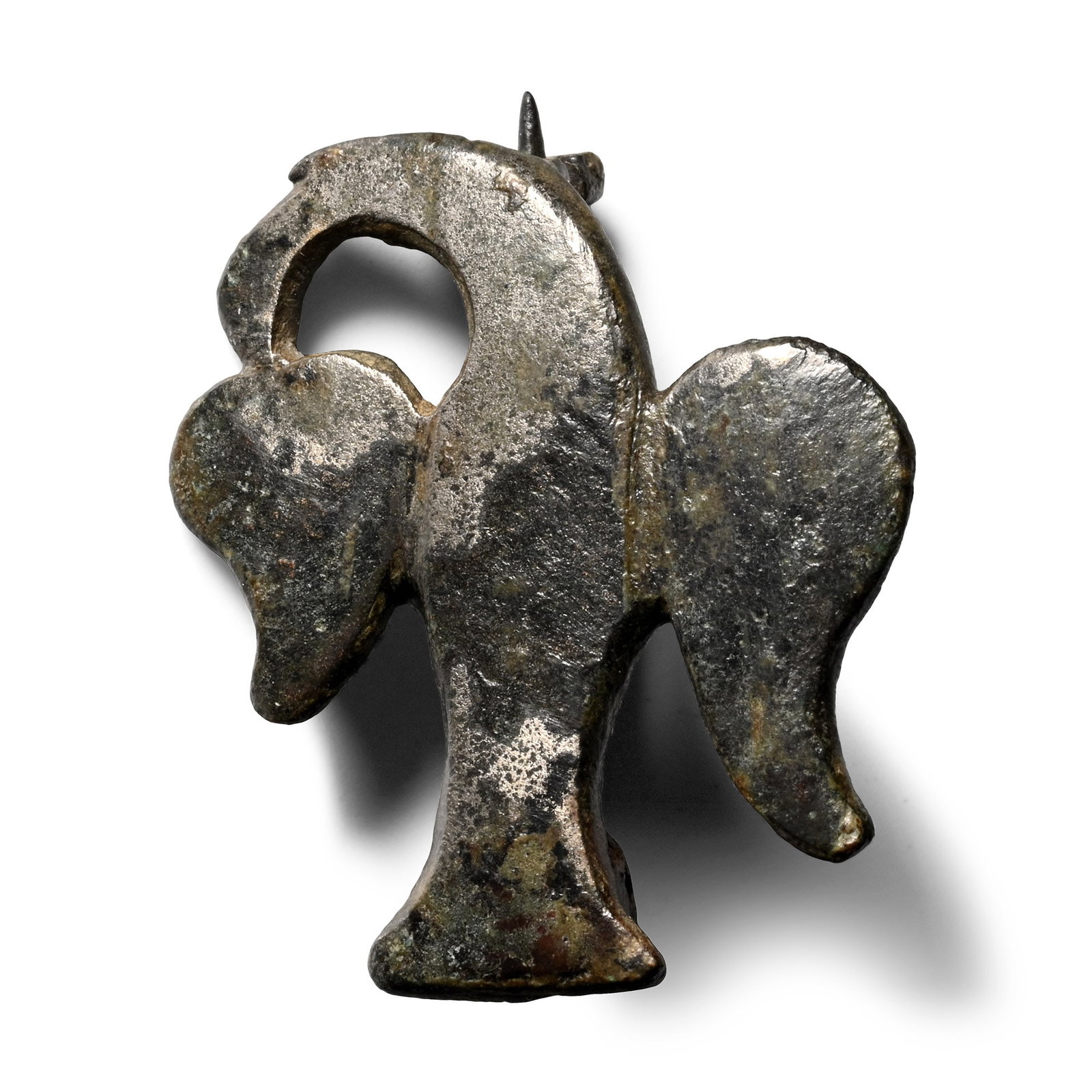 Roman Bronze Eagle Plate Brooch: 2nd-3rd century A.D. Formed as an eagle with its head turned to the side, spread wings and tail, pin and catchplate on the reverse. 8.43 grams, 32 mm (1 1/4 in.). [No Reserve] Ex German art market, 20