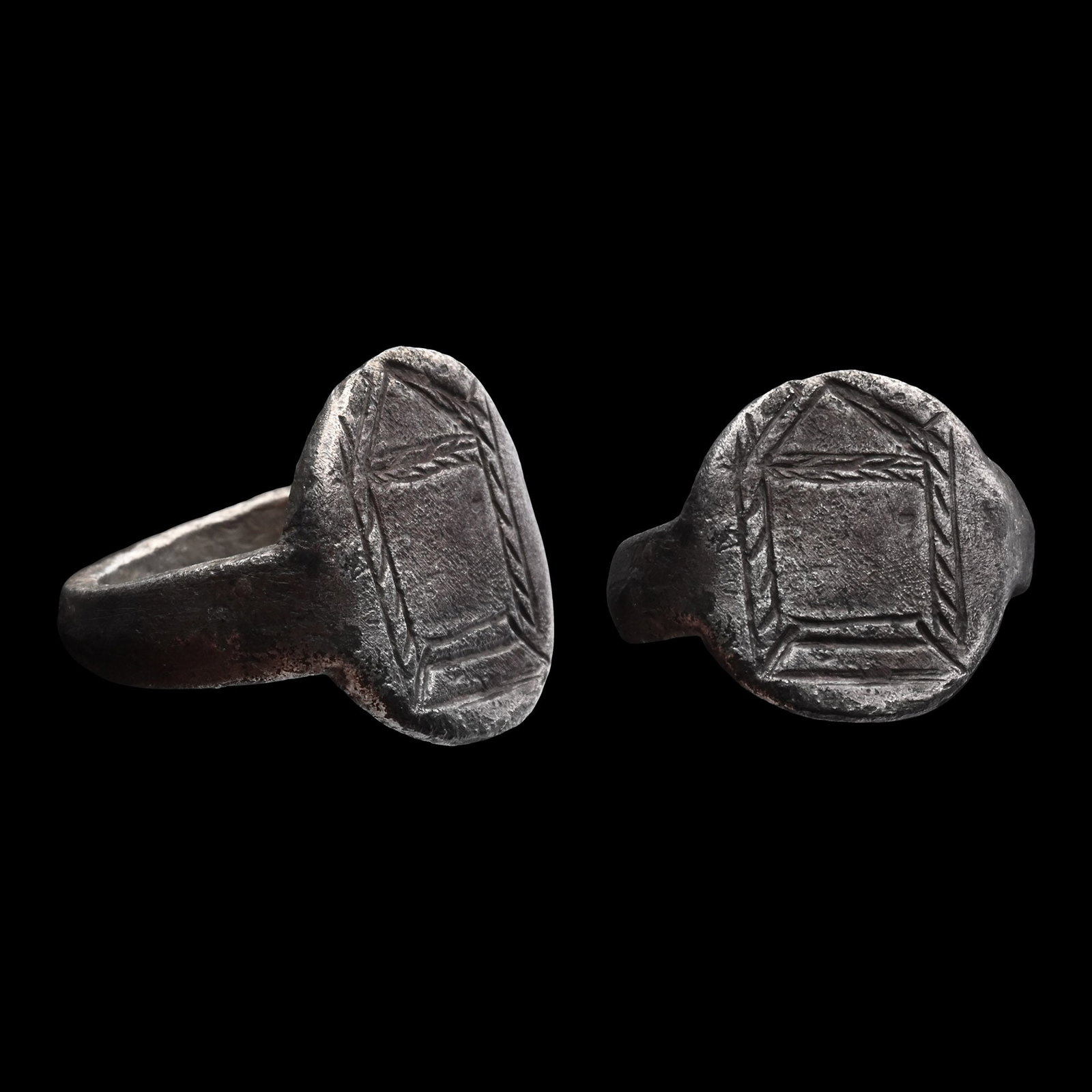 Roman Silver Ring with Building: Circa 2nd-4th century A.D. Comprising a thick hoop and a large oval bezel with a temple(?) with two pillars and a portico. 11.20 grams, 24.82 mm overall, 19.60 mm internal diameter (approximate size B