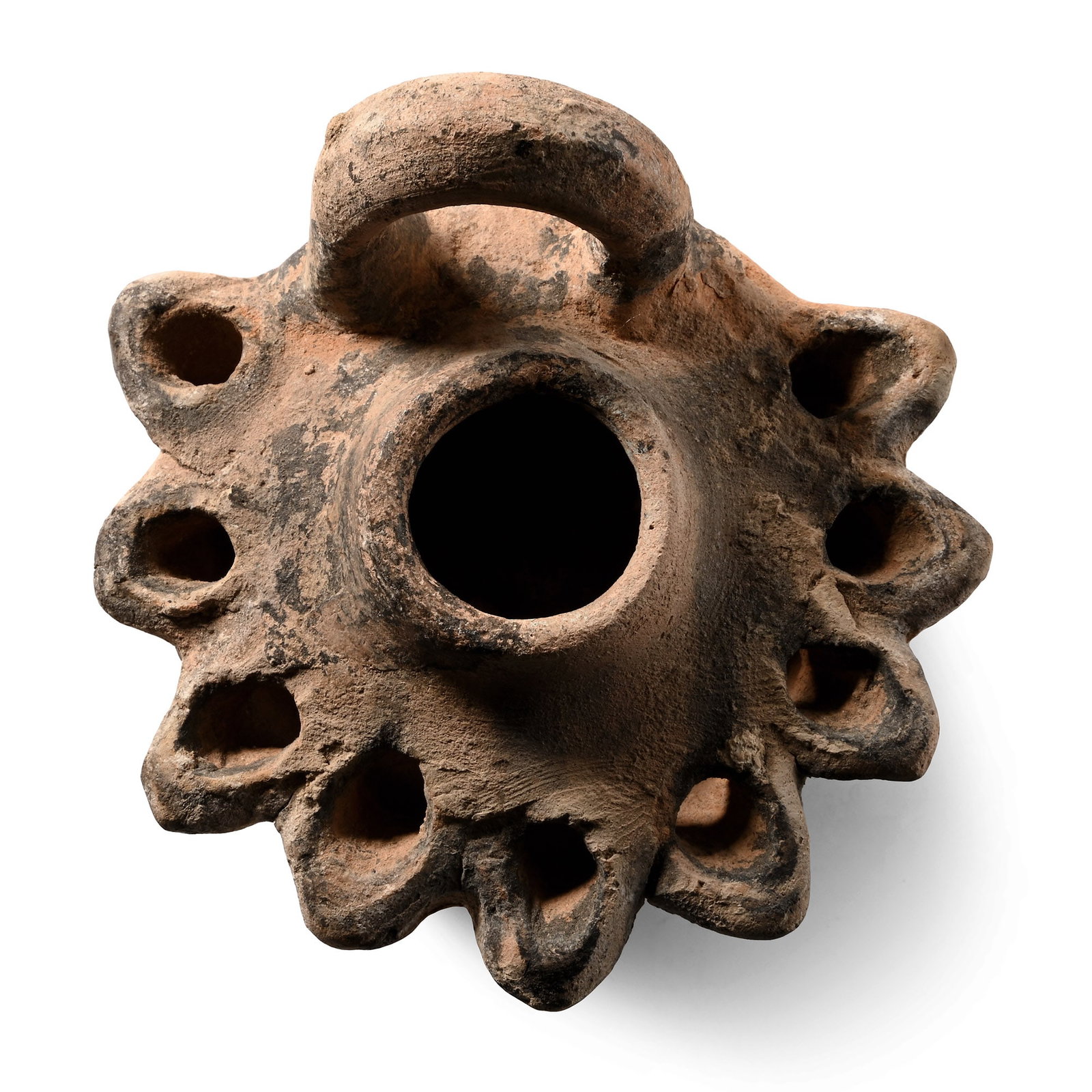 Romano-Jewish Terracotta Multinozzle Oil Lamp: Holy Land, circa 1st-2nd century A.D. High body with a large filler hole and nine oval spouts surrounding, a large U-shaped handle to the rear, inked collector's number '410' on the underside. See Bus
