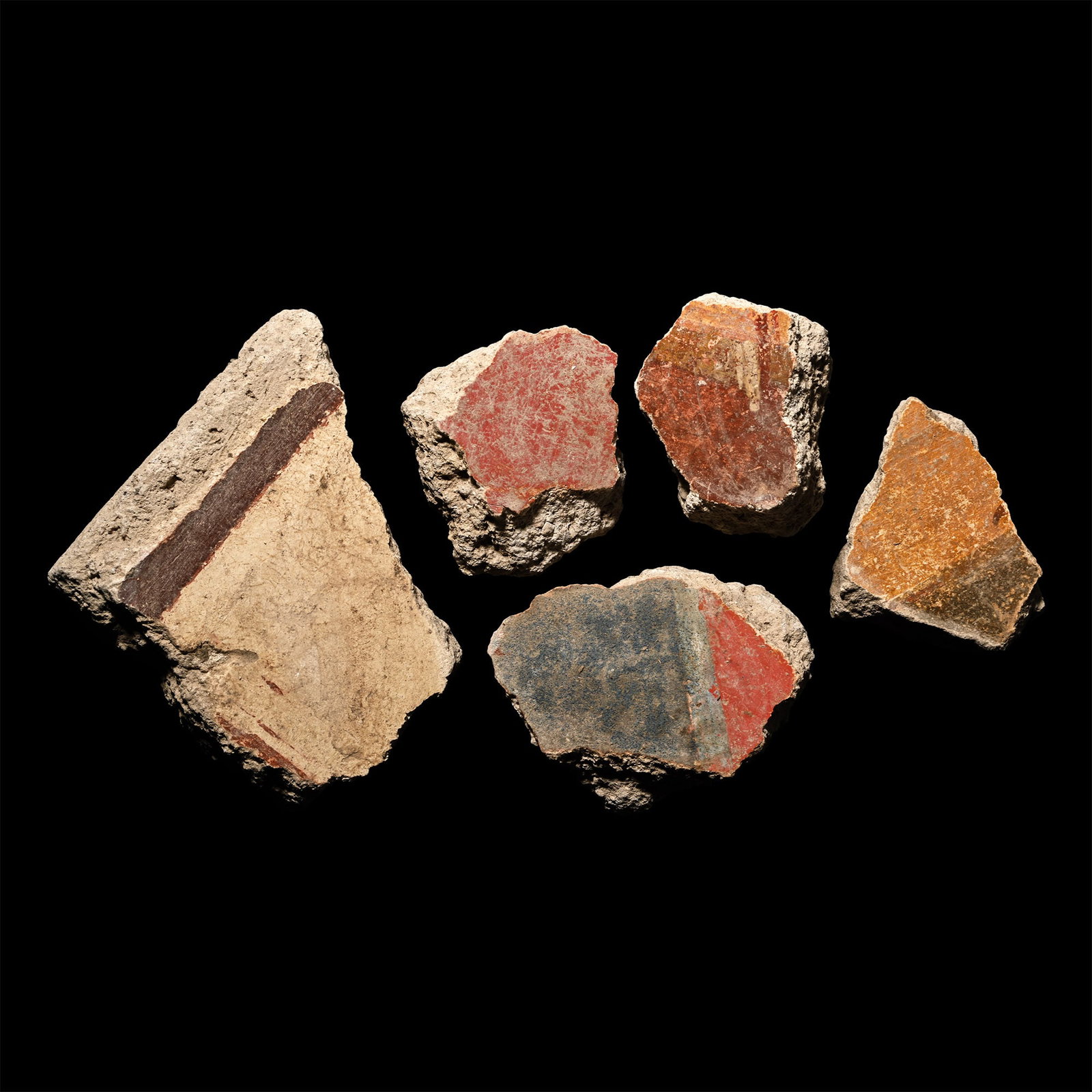 Roman Fresco Wall Plaster Collection: 1st century A.D. Fragments of wall plaster with rendered surface painted with mainly Pompeii red, pale blue, brown and cream detailing; some with an impression of timber laths to the reverse. Cf. Haka