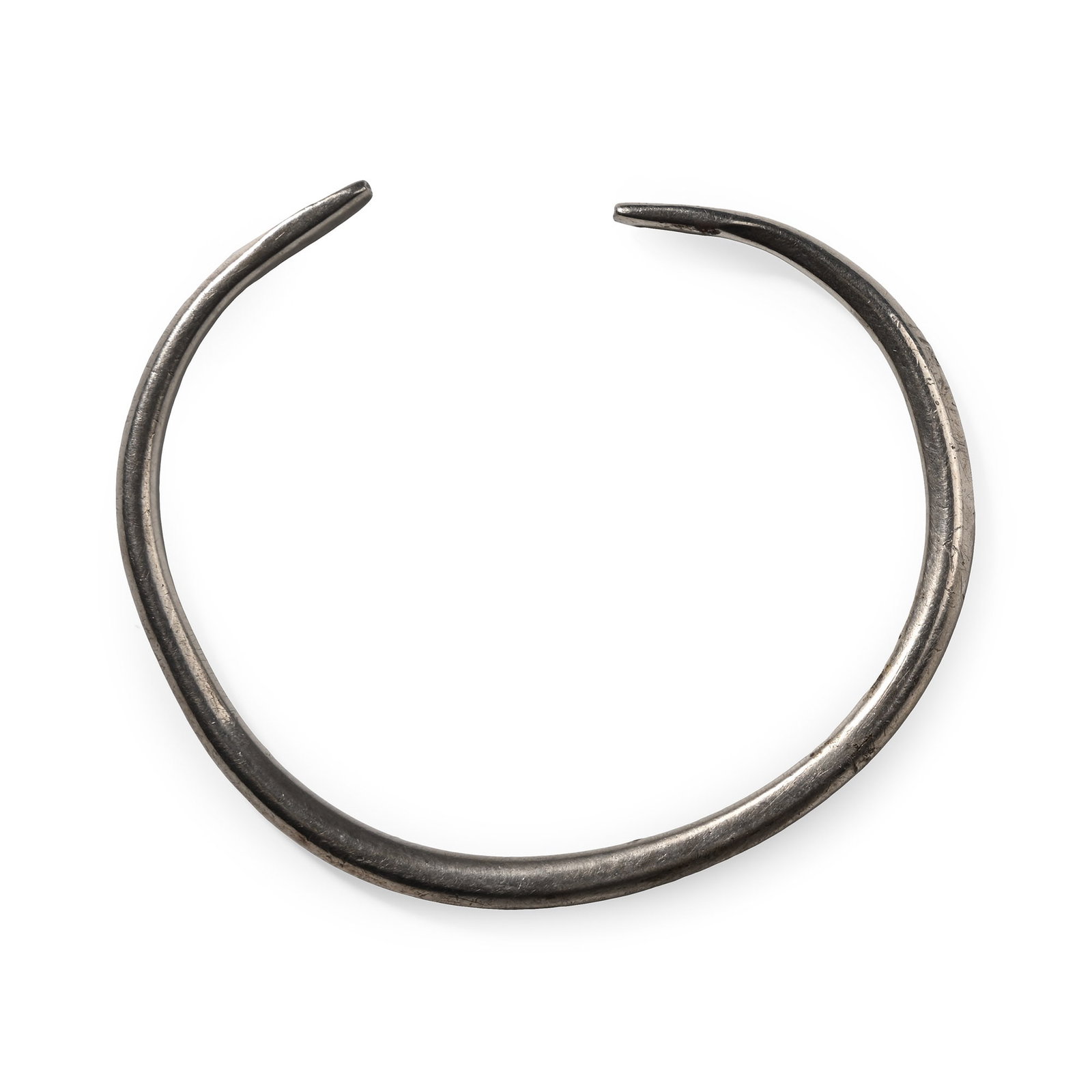 Late Roman Silver Bangle with Snake-Head Terminals: Circa 5th-6th century A.D. Round-section with flattened terminals, punched dot detailing. 25.14 grams, 76 mm (3 in.). Ex property of a gentleman; from a Mayfair, London, UK, gallery. Private collectio