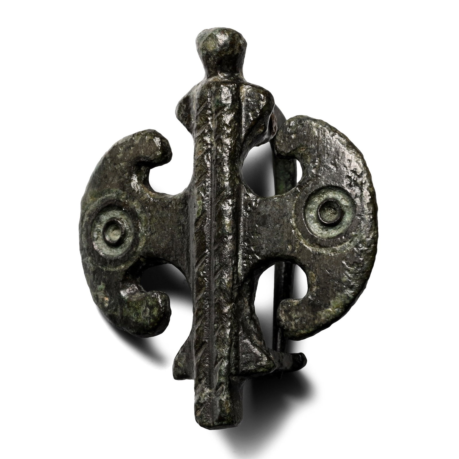 Roman Bronze Double Axe Plate Brooch: 2nd-3rd century A.D. With two pelta-shaped axes and a raised central bar, pin and catchplate on the reverse. 12.5 grams, 38 mm (1 1/2 in.). [No Reserve] Ex German art market, 2000s. Acquired from an E