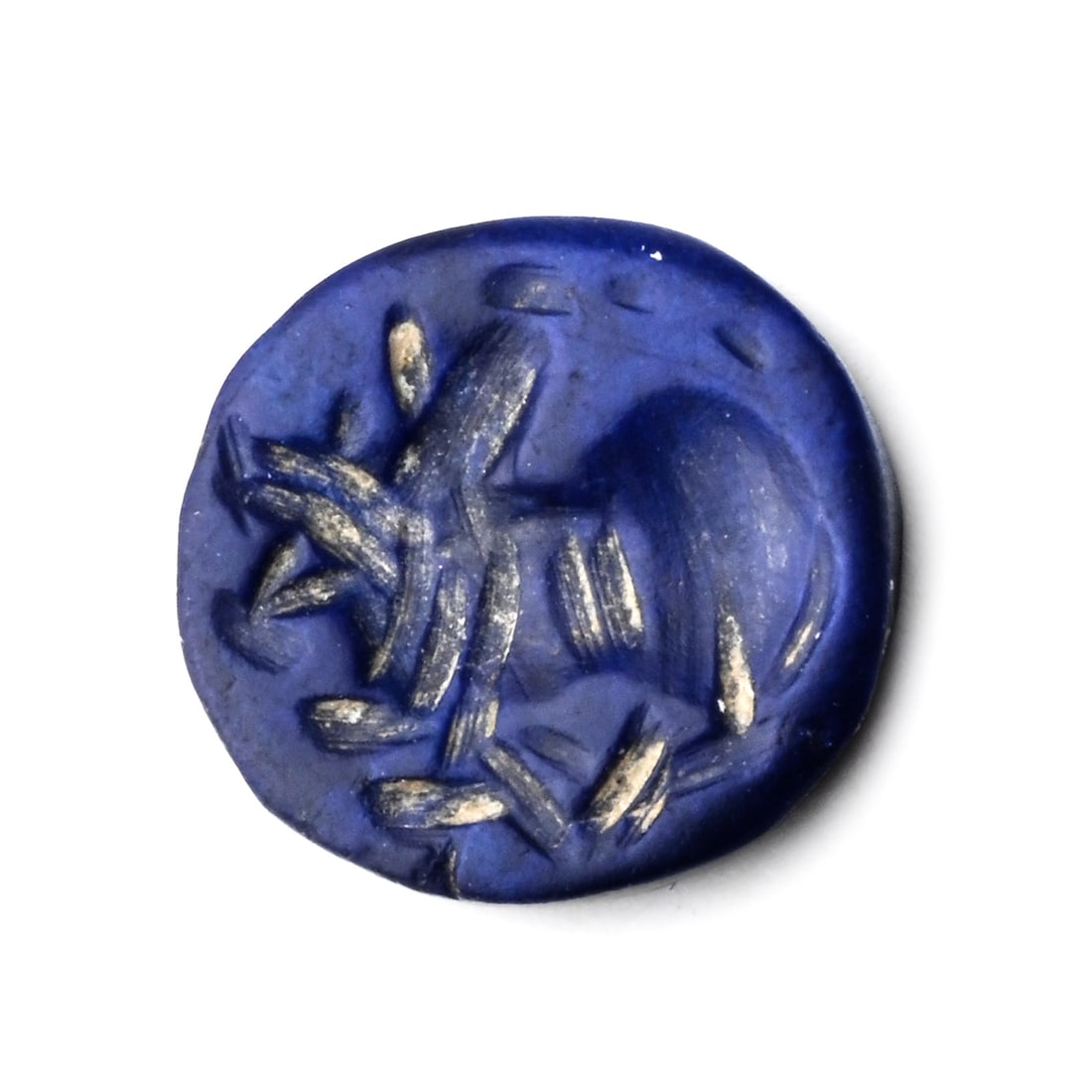 Eastern Roman Dark Blue Gemstone with Rider to Left: 2nd-3rd century A.D. Discoid in plan with an incuse horseman figure. 0.26 grams, 9 mm (3/8 in.). [No Reserve] Property of a European gentleman, acquired from the estate of a London collector (formed b