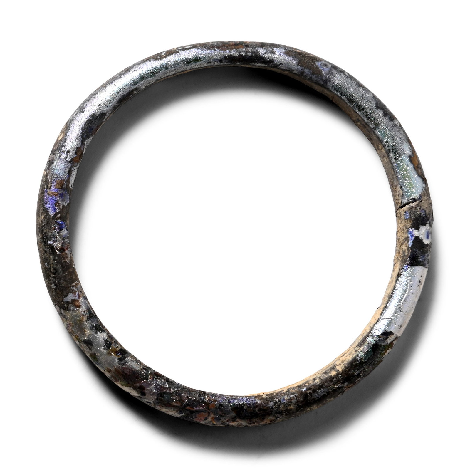 Roman Iridescent Glass Bracelet: 1st-4th century A.D. D-shaped in section with iridescent surface. 3.96 grams, 46 mm (1 3/4 in.). [No Reserve] From the private collection of Mr Brian Edwards, New Malden, Surrey, UK, formed from the l