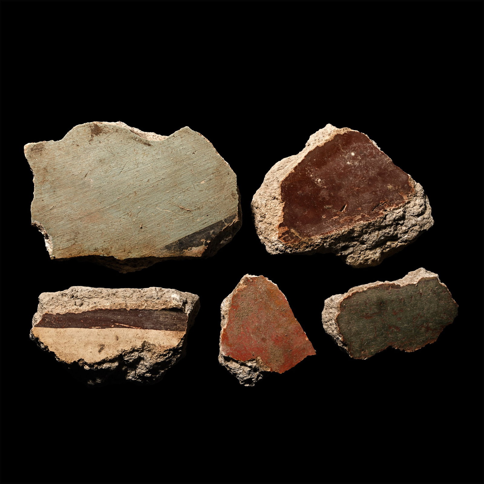 Roman Fresco Wall Plaster Collection: 1st century A.D. Fragments of wall plaster with rendered surface painted with mainly Pompeii red, pale blue, brown and white detailing; some with an impression of timber laths to the reverse. Cf. Haka