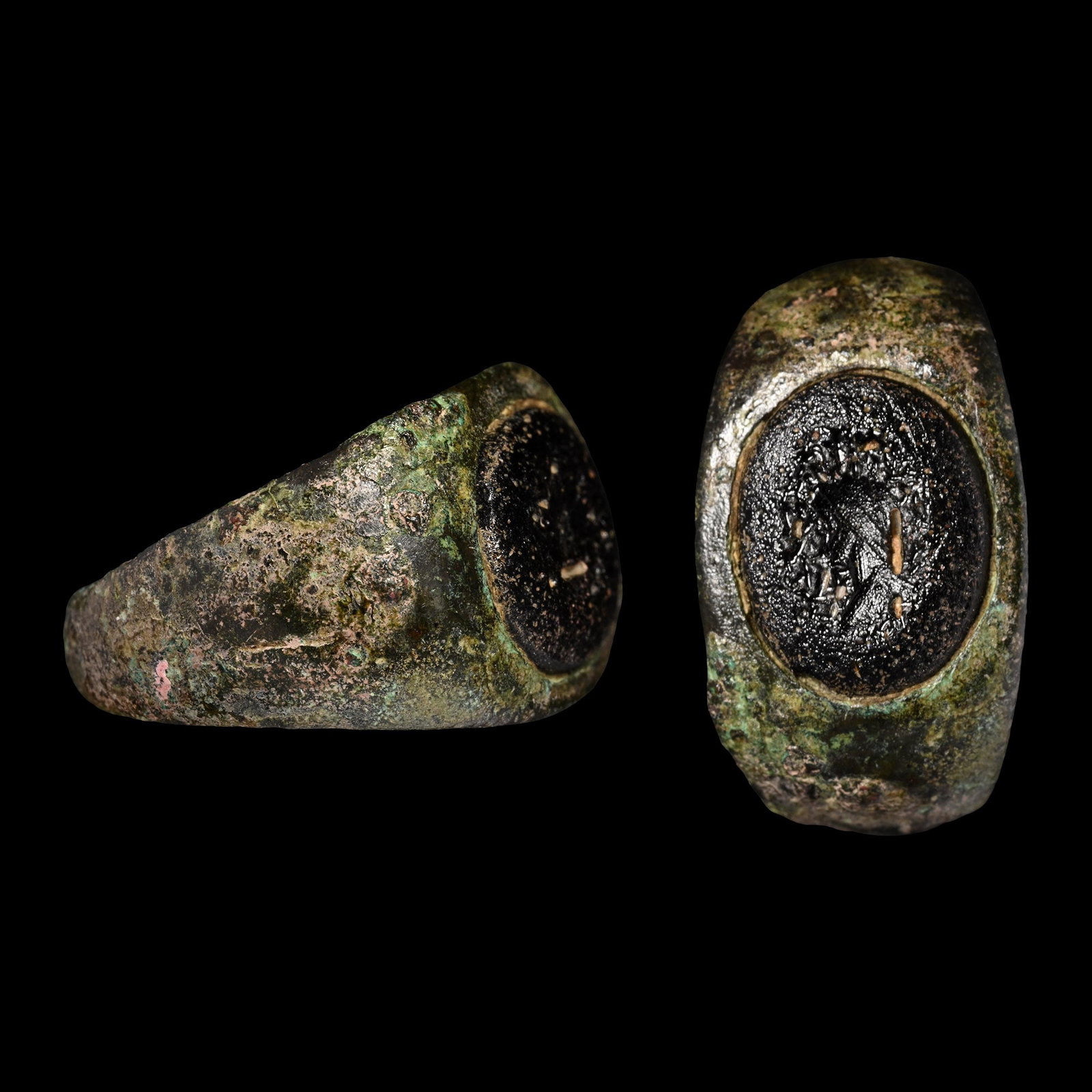 Roman Bronze Ring with Glass Gem: 2nd-3rd century A.D. With broad tapering shoulders, plaque inset with an ellipsoid intaglio profile bust. 6.92 grams, 24.70 mm overall, 20.35 x 16.77 mm internal diameter (approximate size British O 1