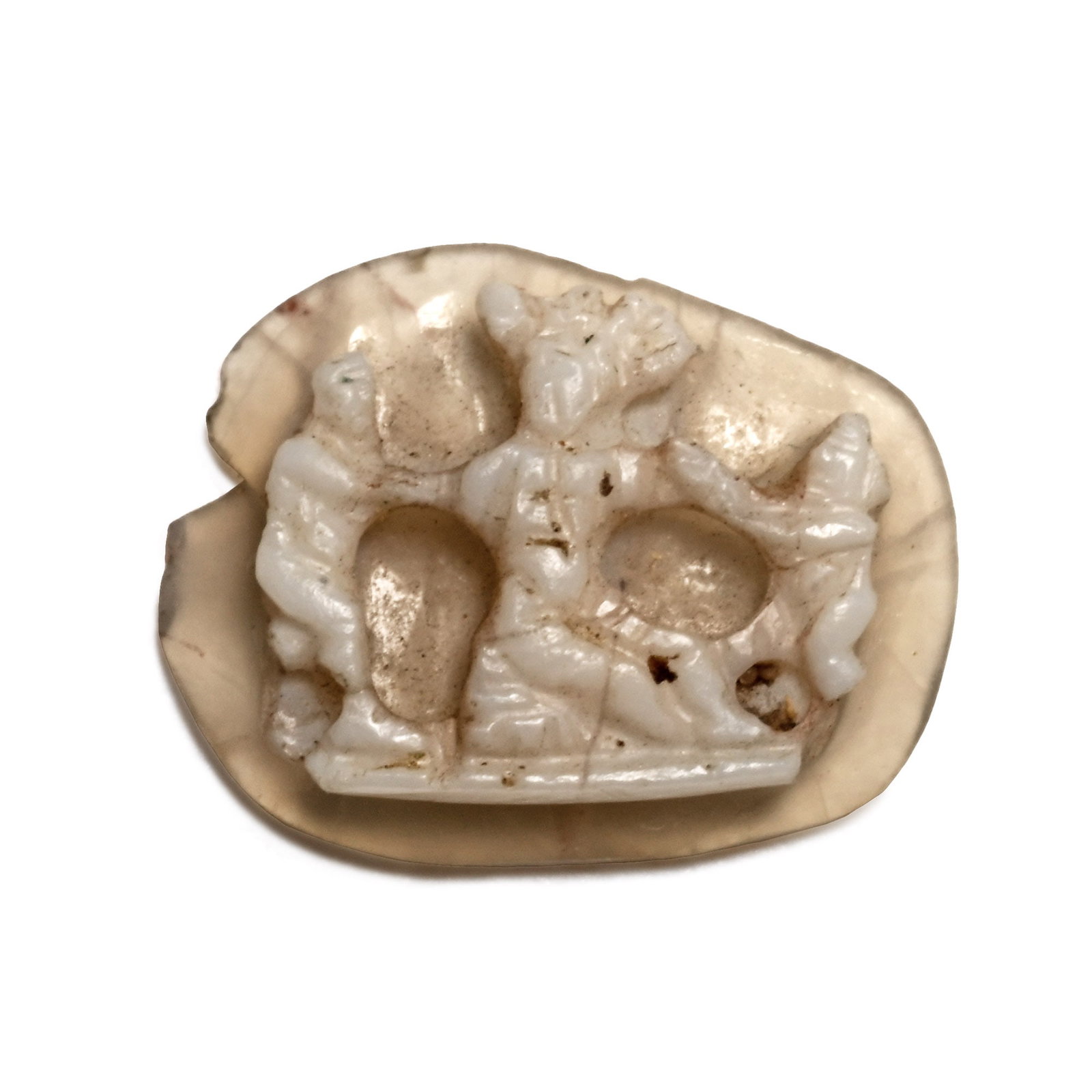Roman Agate Cameo with Figures: Circa 2nd century A.D. Carved from two-toned stone showing a raised image of a seated figure flanked by two smaller figures reaching towards the central figure. 0.17 grams, 9 mm (3/8 in.). [No Reserve