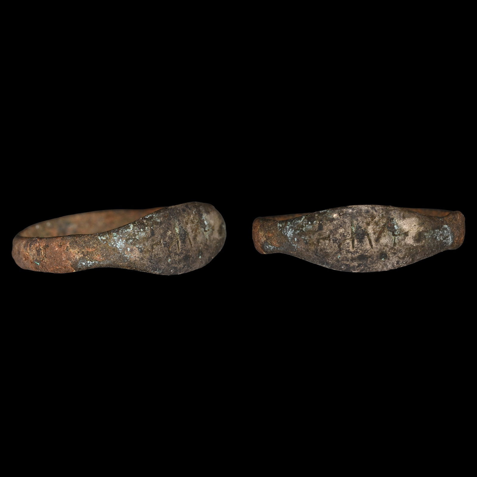 Roman Bronze Ring with Inscription: 3rd-4th century A.D. With slender hoop and ellipsoid bezel, three incised characters; with old collector's ticket. 1.34 grams, 19.80 mm overall, 17.25 mm internal diameter (approximate size British L 