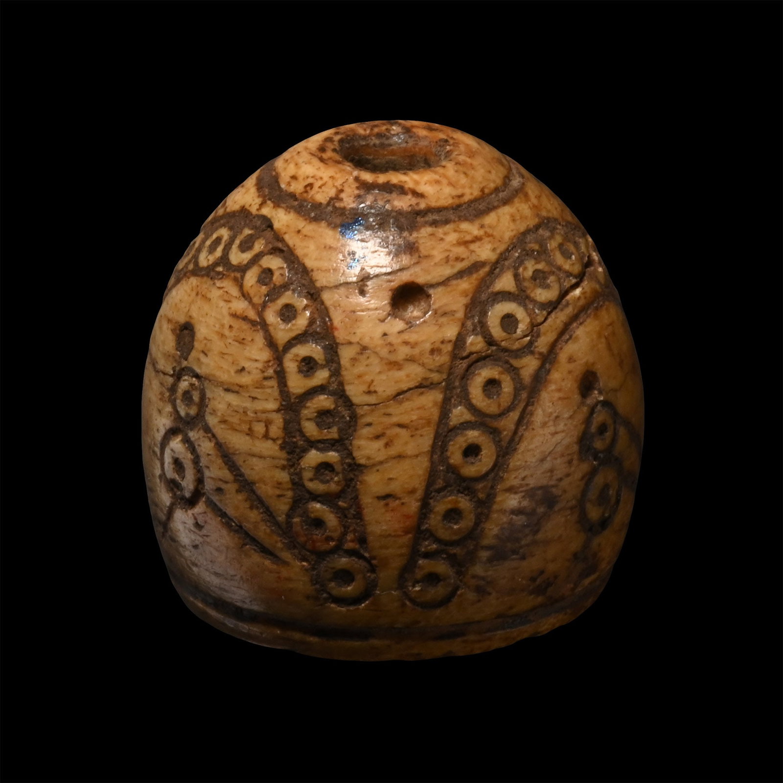 Byzantine Engraved Bone Spindle Whorl with Birds Below Canopy: Circa 8th-12th century A.D. Barrel-shaped with incised ring-and-dot ornament forming an arcade. 7.78 grams, 17.78 mm (5/8 in.). Ex Abelita family collection, 1980s-2000s. TimeLine Auctions follows a r