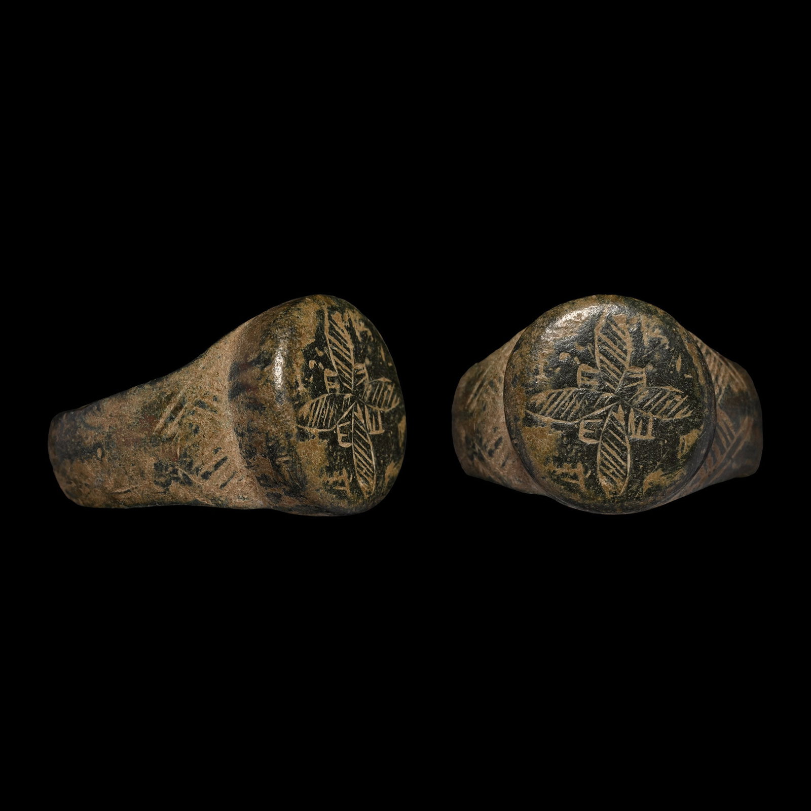Byzantine Bronze Ring with Floral Cross: Circa 6th-8th century A.D. With broad hoop and stud to the underside, drum-shaped bezel with hatching to the shoulders, incuse hatched cross. 15.11 grams, 26.76 mm overall, 19.02 mm internal diameter 