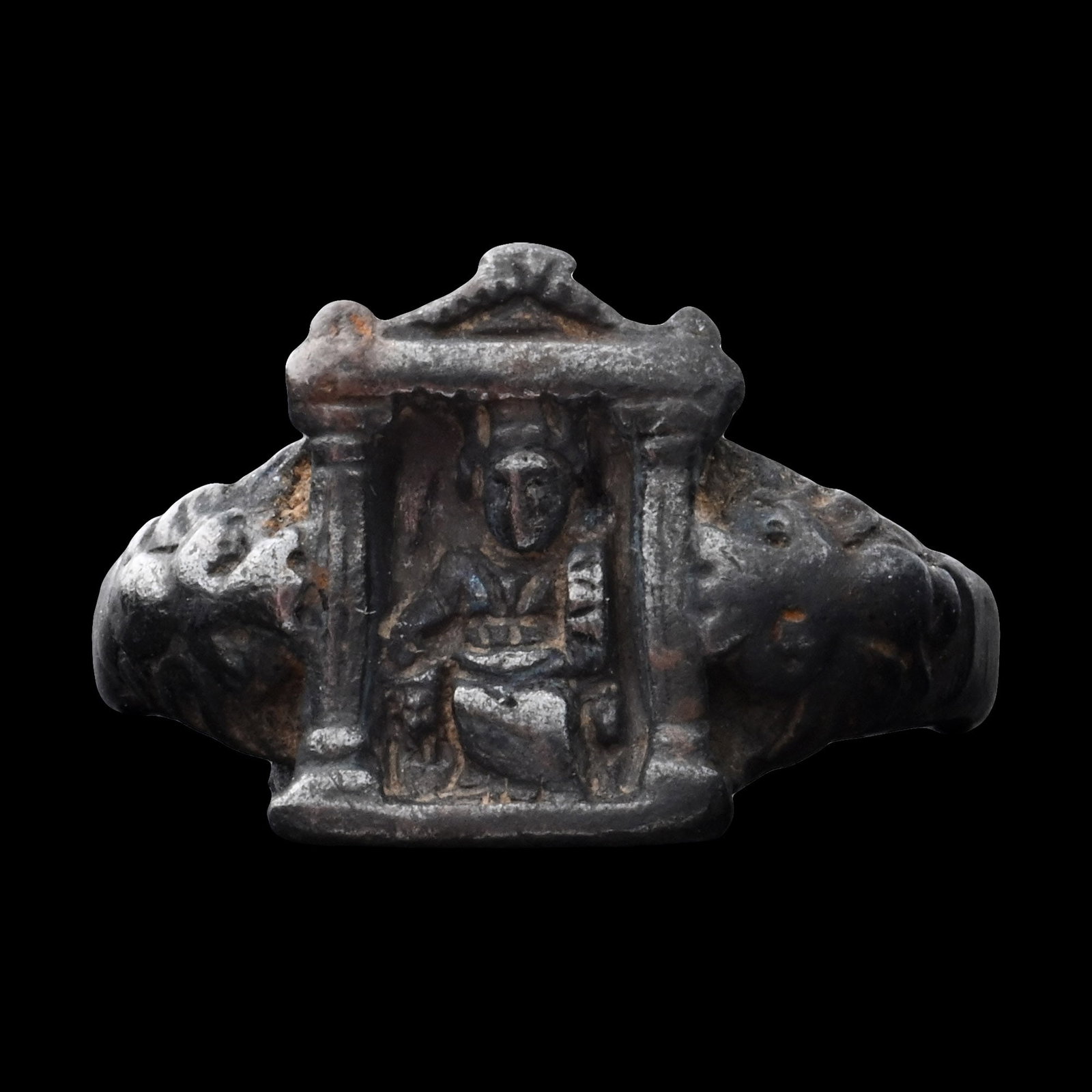 Byzantine Silver Architectural Ring Bezel: Circa 6th-8th century A.D. The bezel formed as an open facade of a building with a pediment, a robed figure inside, seated on a throne with lion-head arms. 6.67 grams, 22 mm (7/8 in.). [No Reserve] Fr