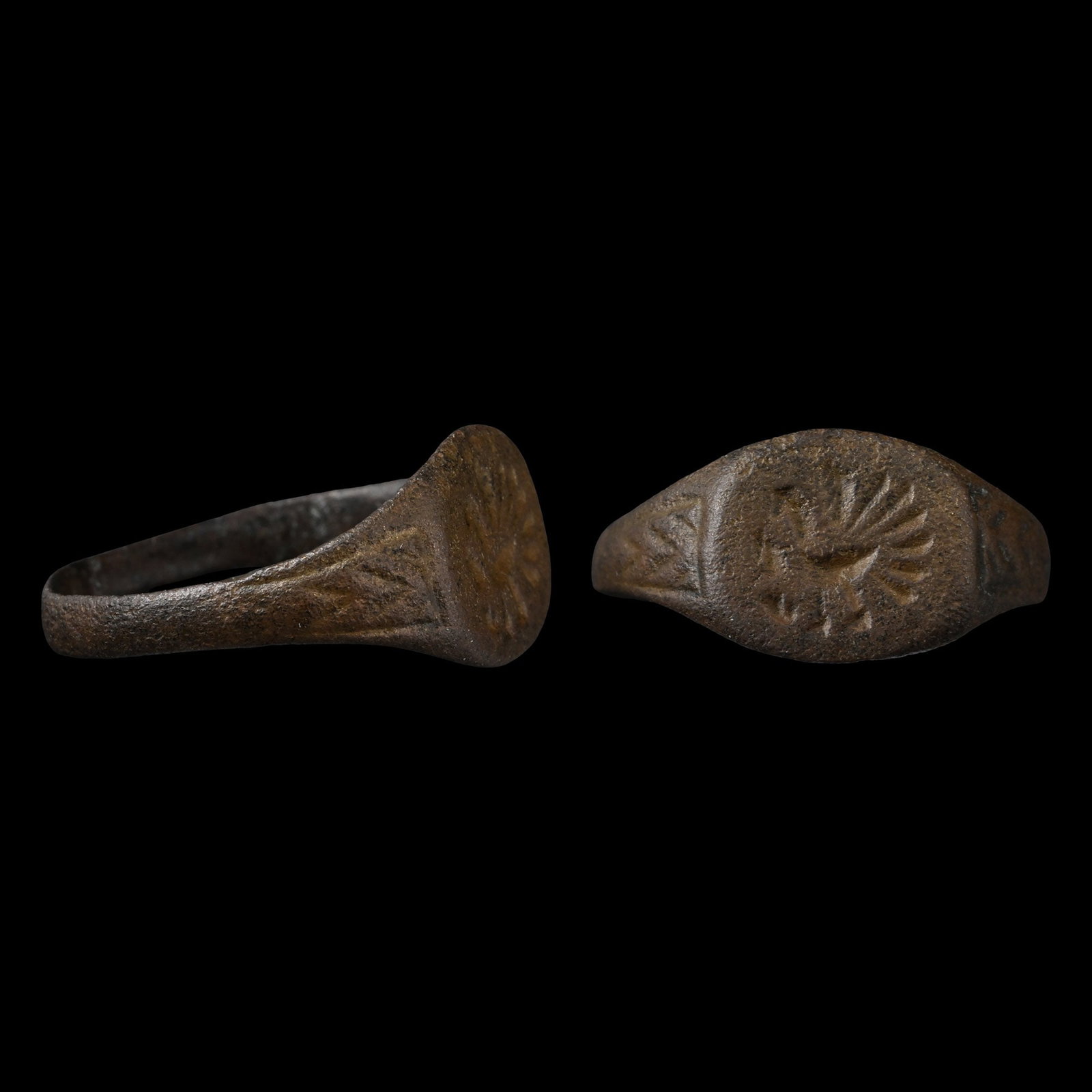 Large Byzantine Bronze Ring with Displaying Peacock: 6th-8th century A.D. Flat-section hoop and an oval bezel with an advancing peacock with spread tail feathers. 3.03 grams, 23.54 mm overall, 20.60 x 21.04 mm internal diameter (approximate size British